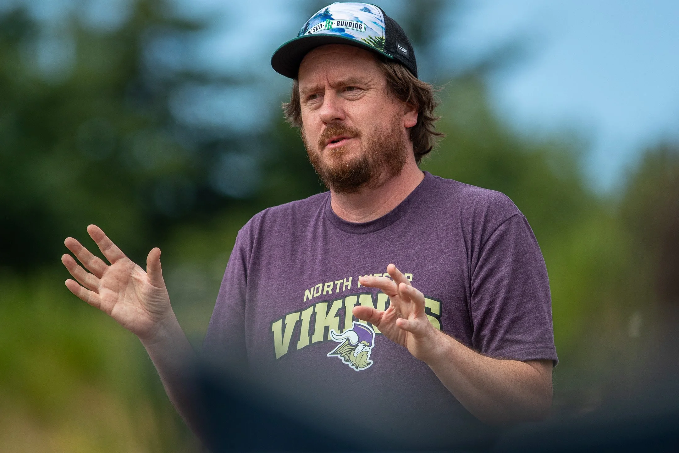 Jonathan Ericksen, Assistant Cross Country Coach at North Kitsap High School, talking with campers about running shoes at Cascadia Running Camp.
