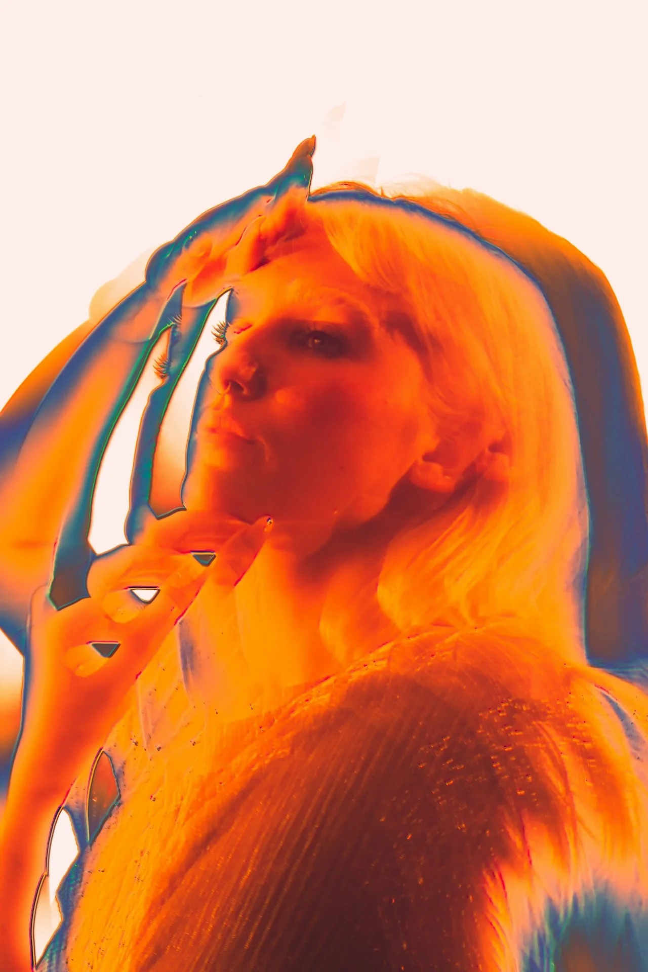 A person with long hair holding a phone to their ear, with a surreal, abstract orange and blue effects distortion.