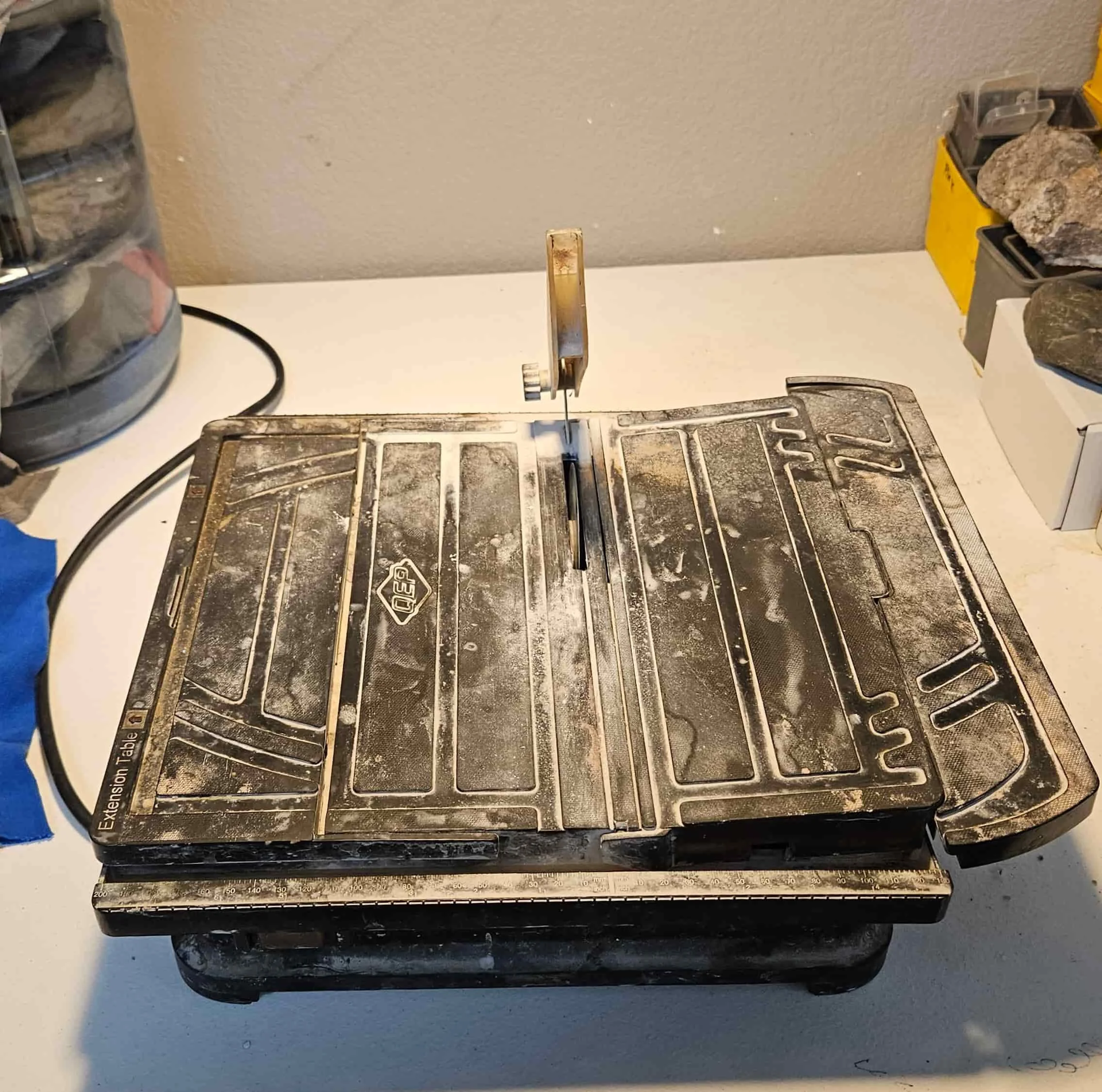 well used four inch trim saw on a white table.