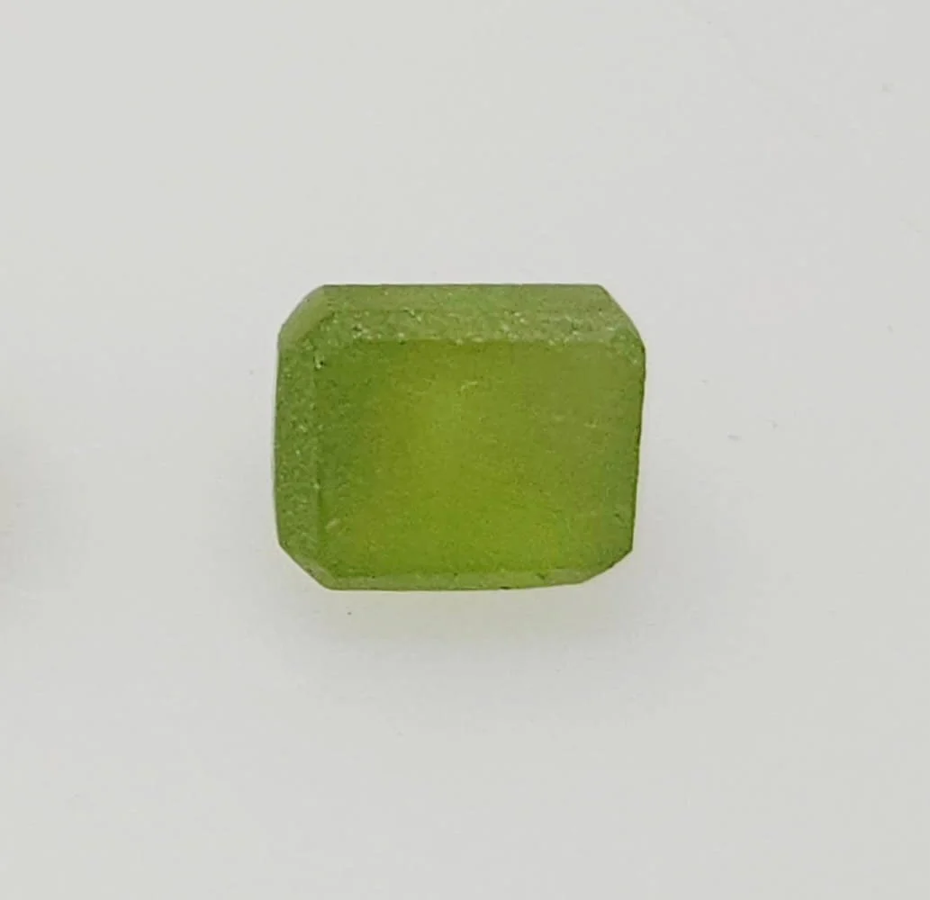 Peridot preform close up on a white background.