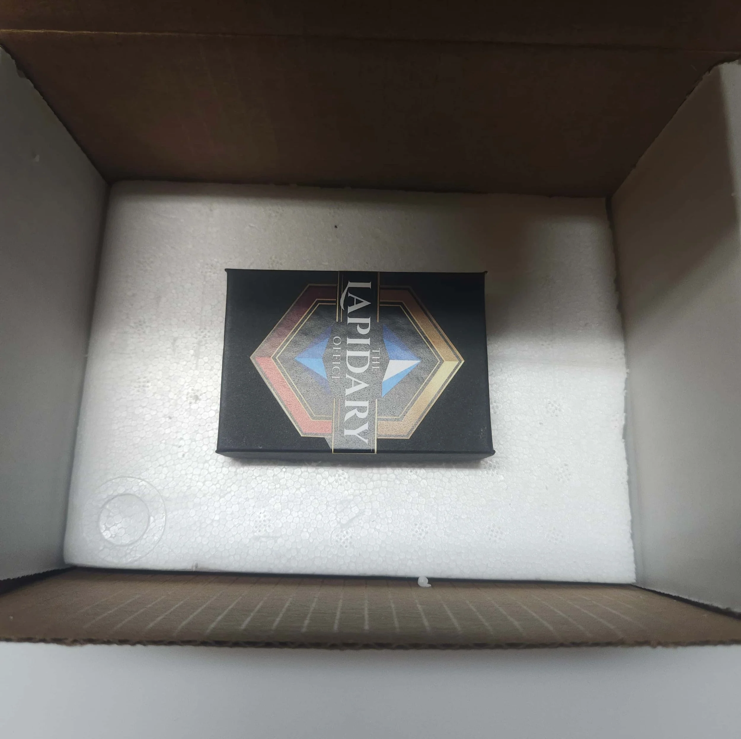 Inside view of a cardboard box showing a card game box titled 'The Law Society of Upper Canada' with colorful decorative design.