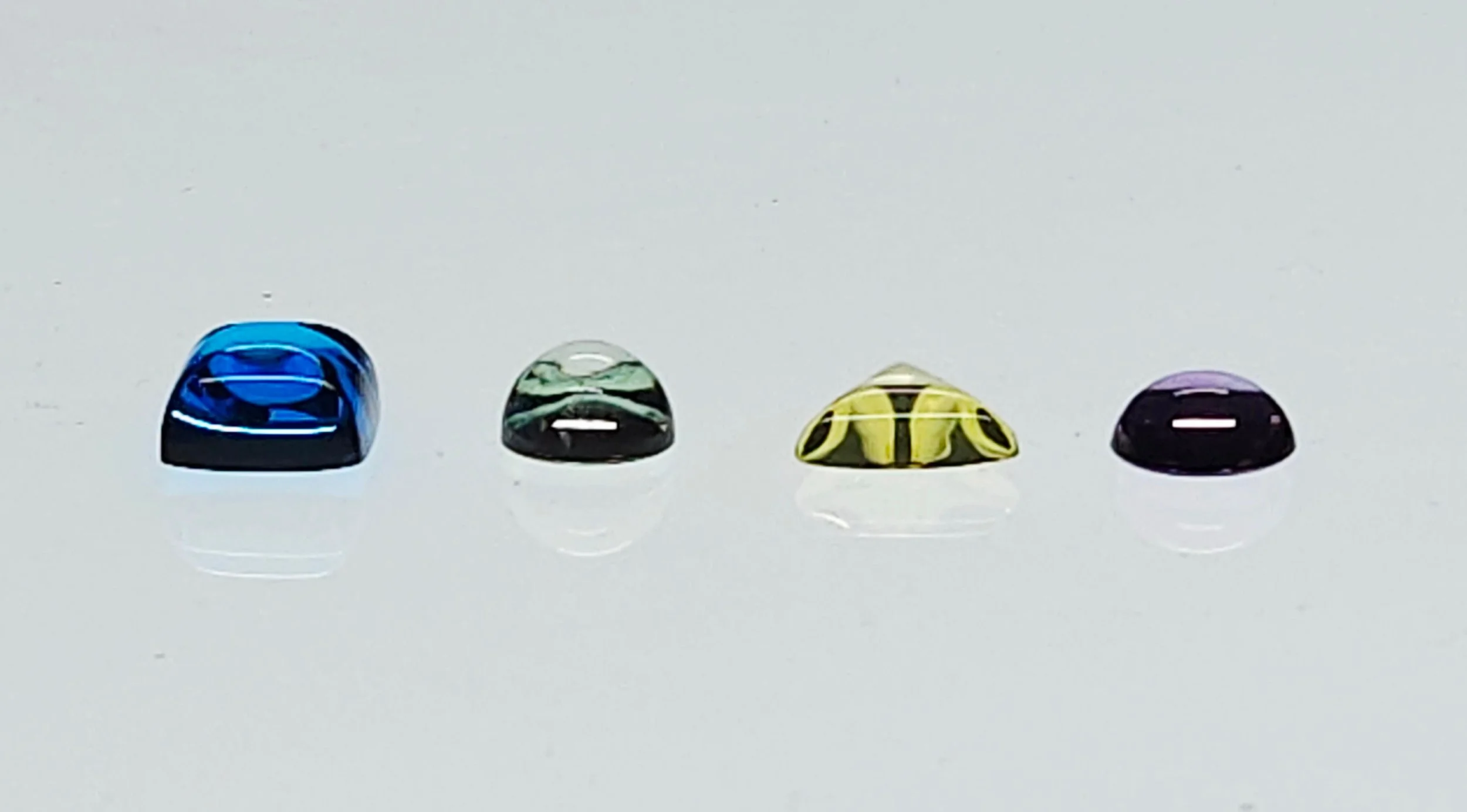 Four quartz cabochons resting on a light table