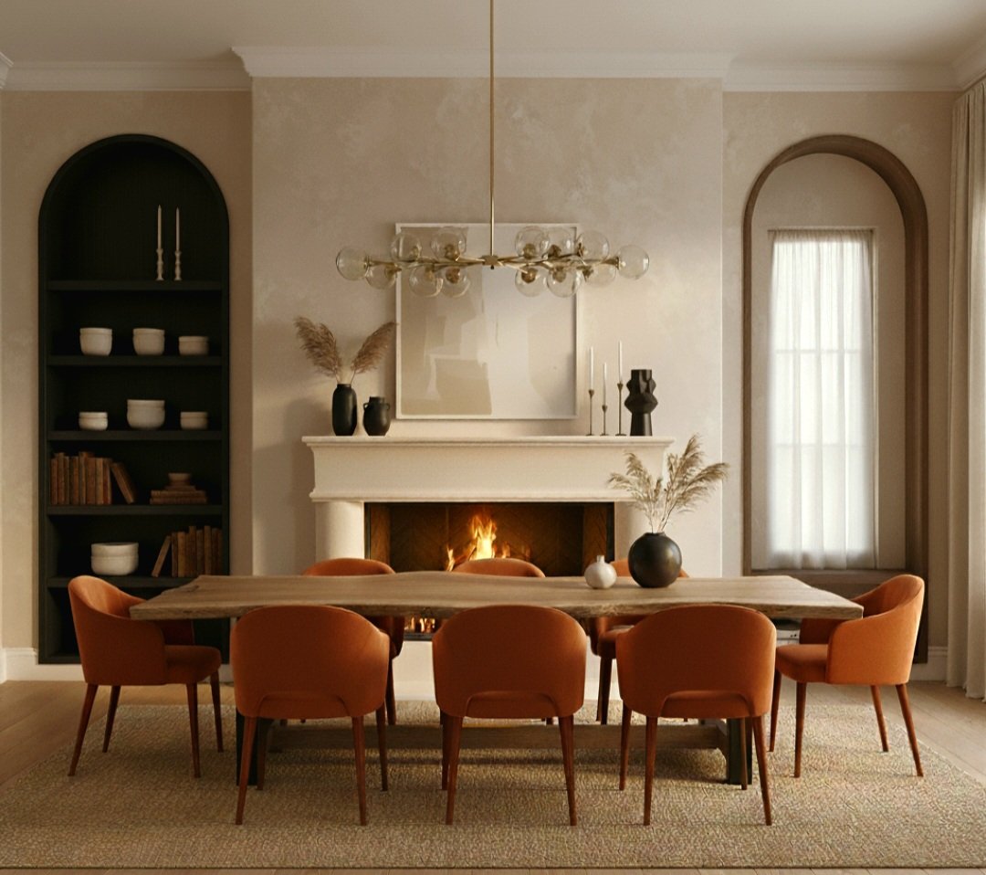 Living room with a wooden dining table surrounded by nine burnt orange chairs, fireplace with a fire, and built-in shelves filled with books and decorative objects. There is a large mirror above the textured fireplace and a modern chandelier hanging 