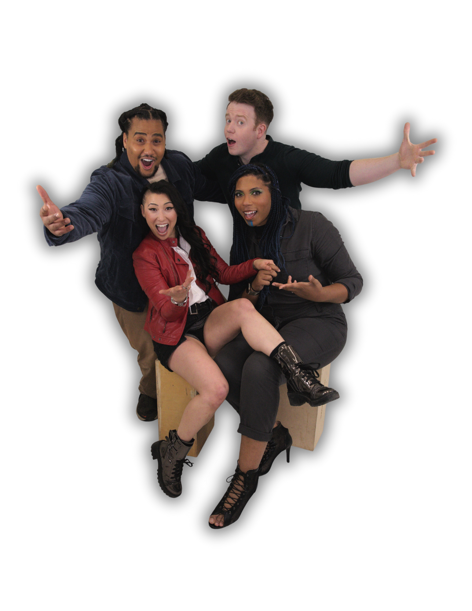 Lou Wilson and Brennan Lee Mulligan stand behind Erika Ishii and Aabria Iyengar who are sitting. All four have their mouths open in joy and arms outstretched as Erika and Aabria hold hands and Lou and Brennan wrap their arms around each other.