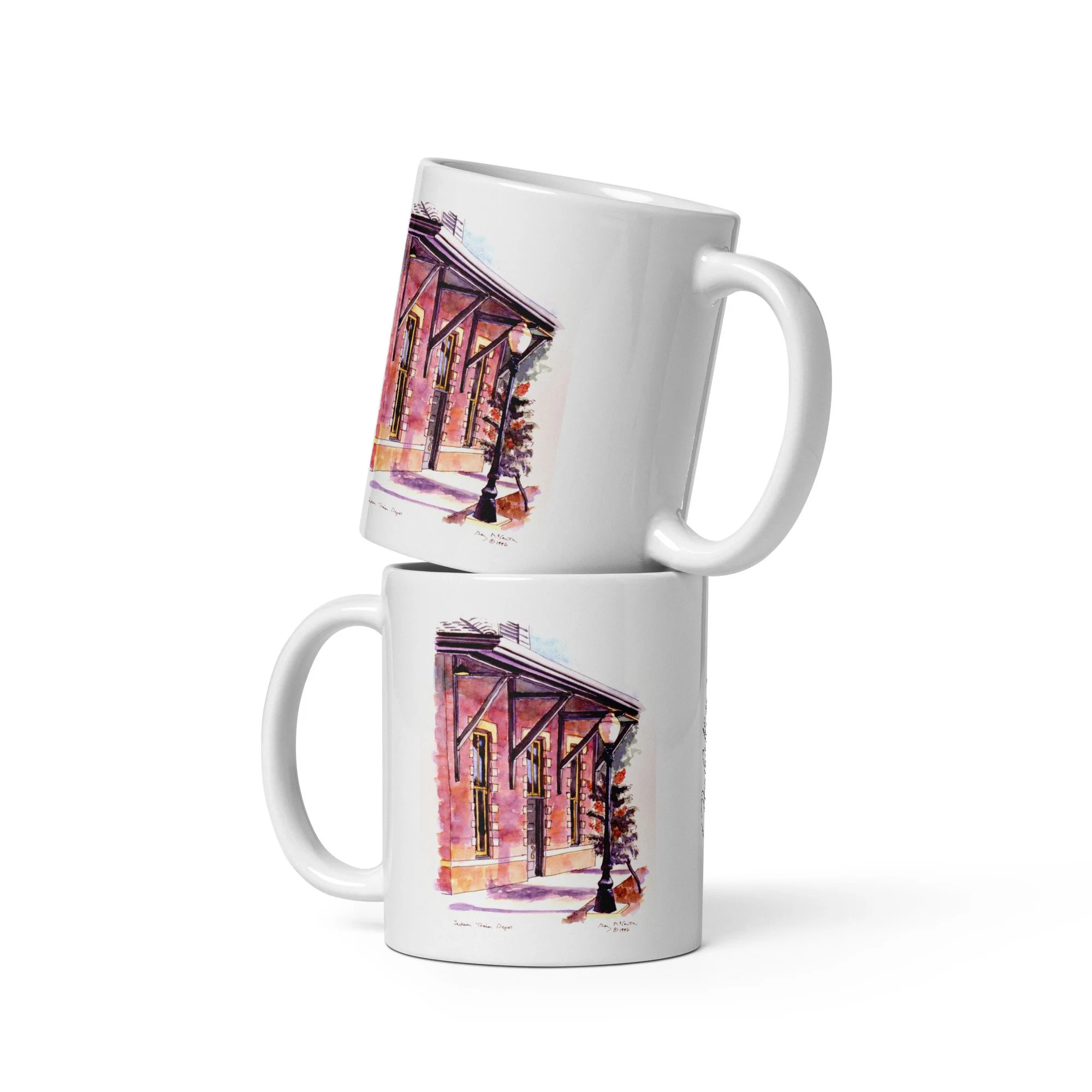 11 oz white ceramic mug with Jackson Train Depot watercolor wrap by Beverly G. McCarter, Tennessee depot as portal of arrival in soft light.