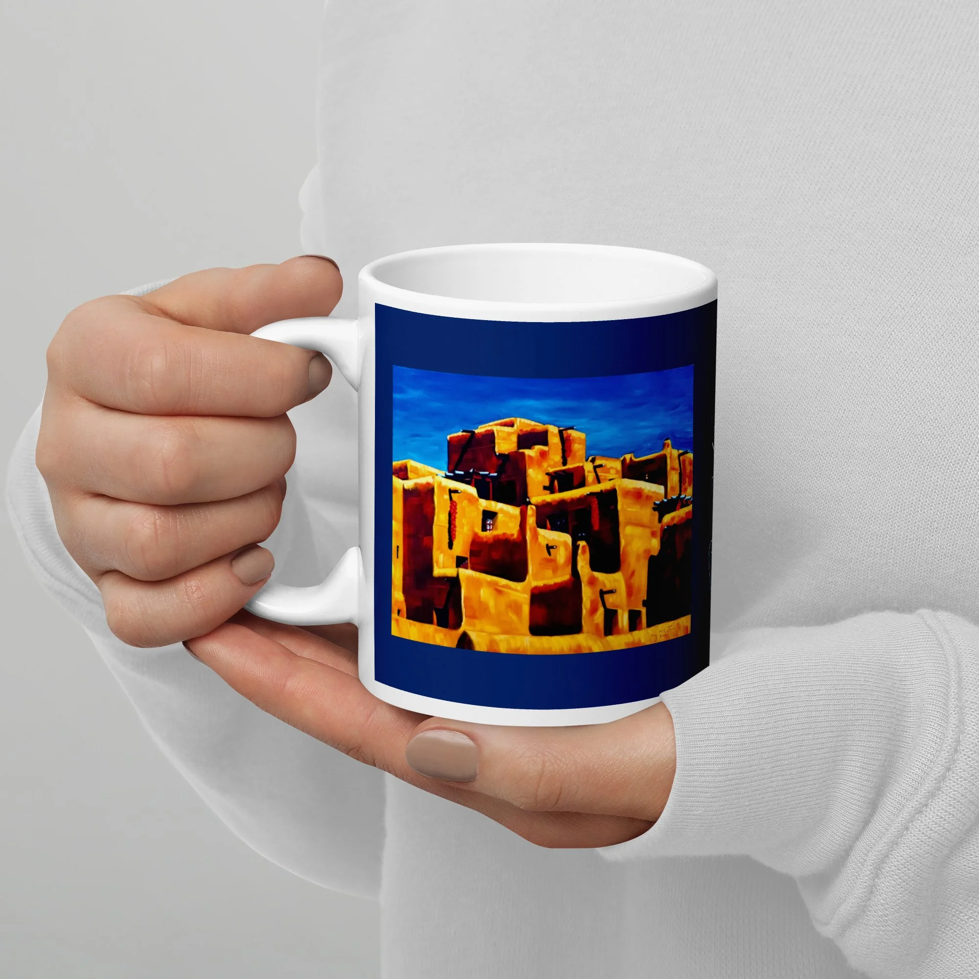 ”The Peppers” oil by Beverly G. McCarter – glowing adobe walls and hanging red chilis under a cobalt desert sky, printed front and back on 11 oz mug with deep cobalt-night-blue wrap.