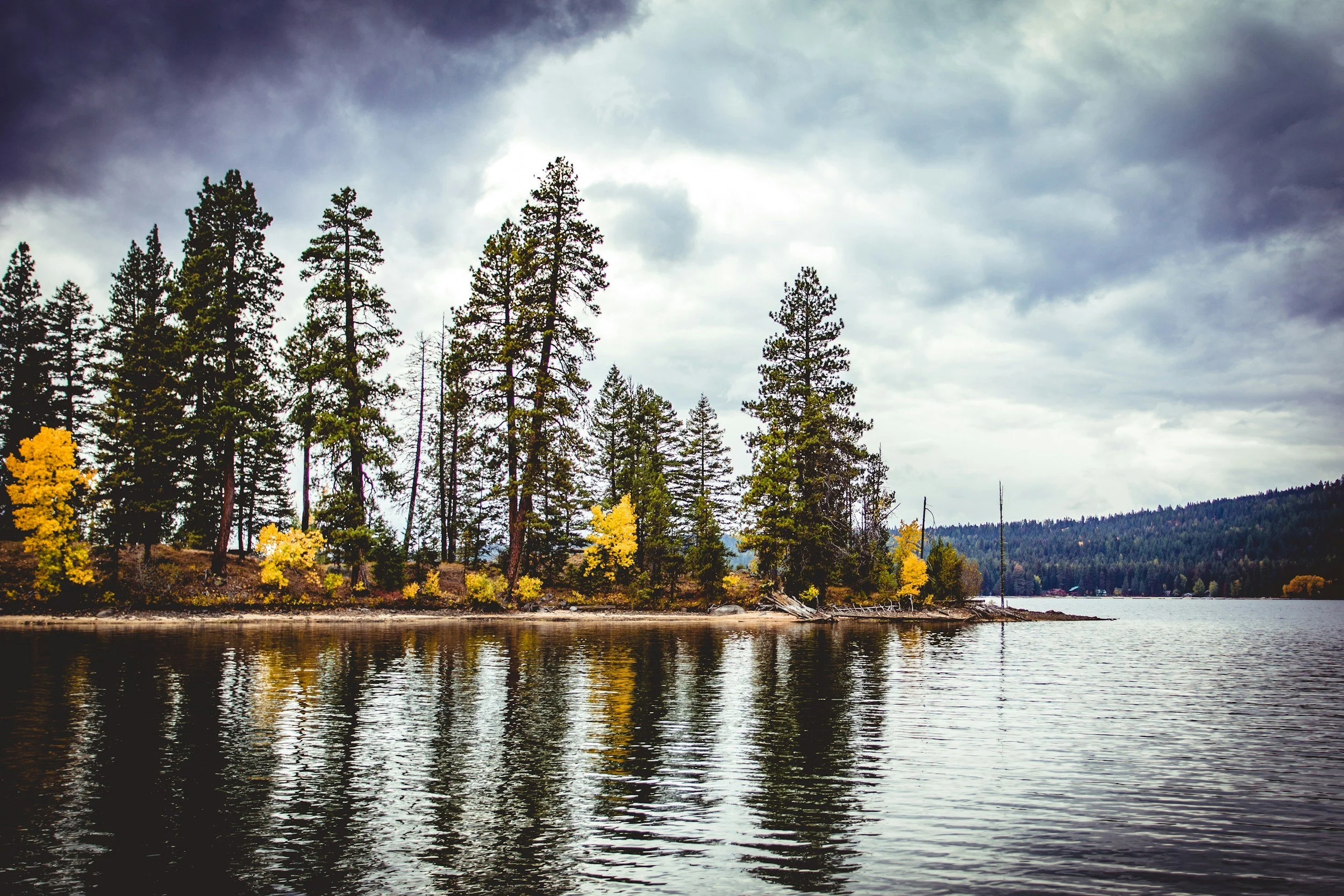 Payette Lake in McCall, Idaho with reflections of trees on the water.
