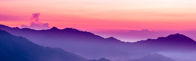 Mountain range at sunset with pink and purple sky