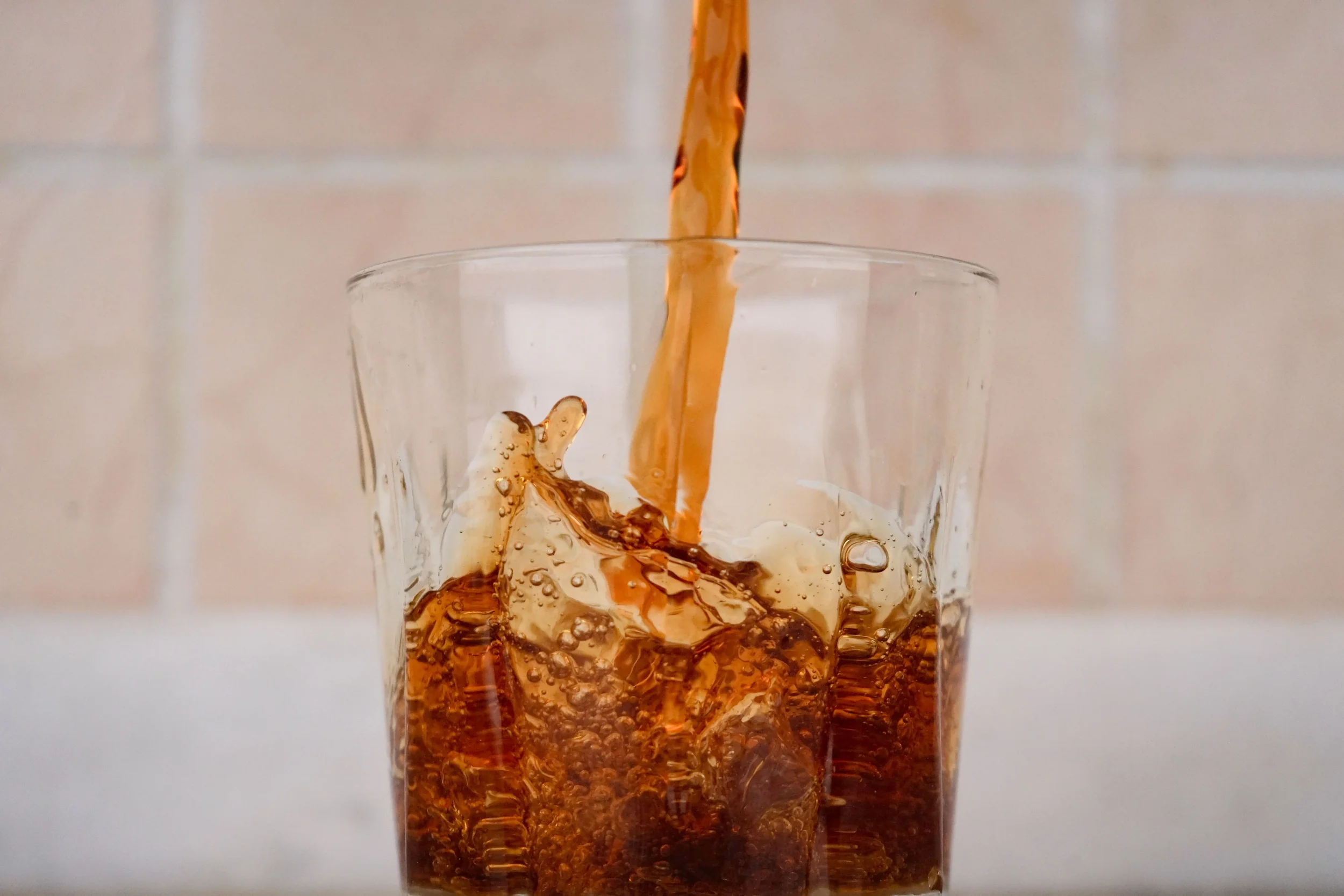 Diet soda being poured into clear glass