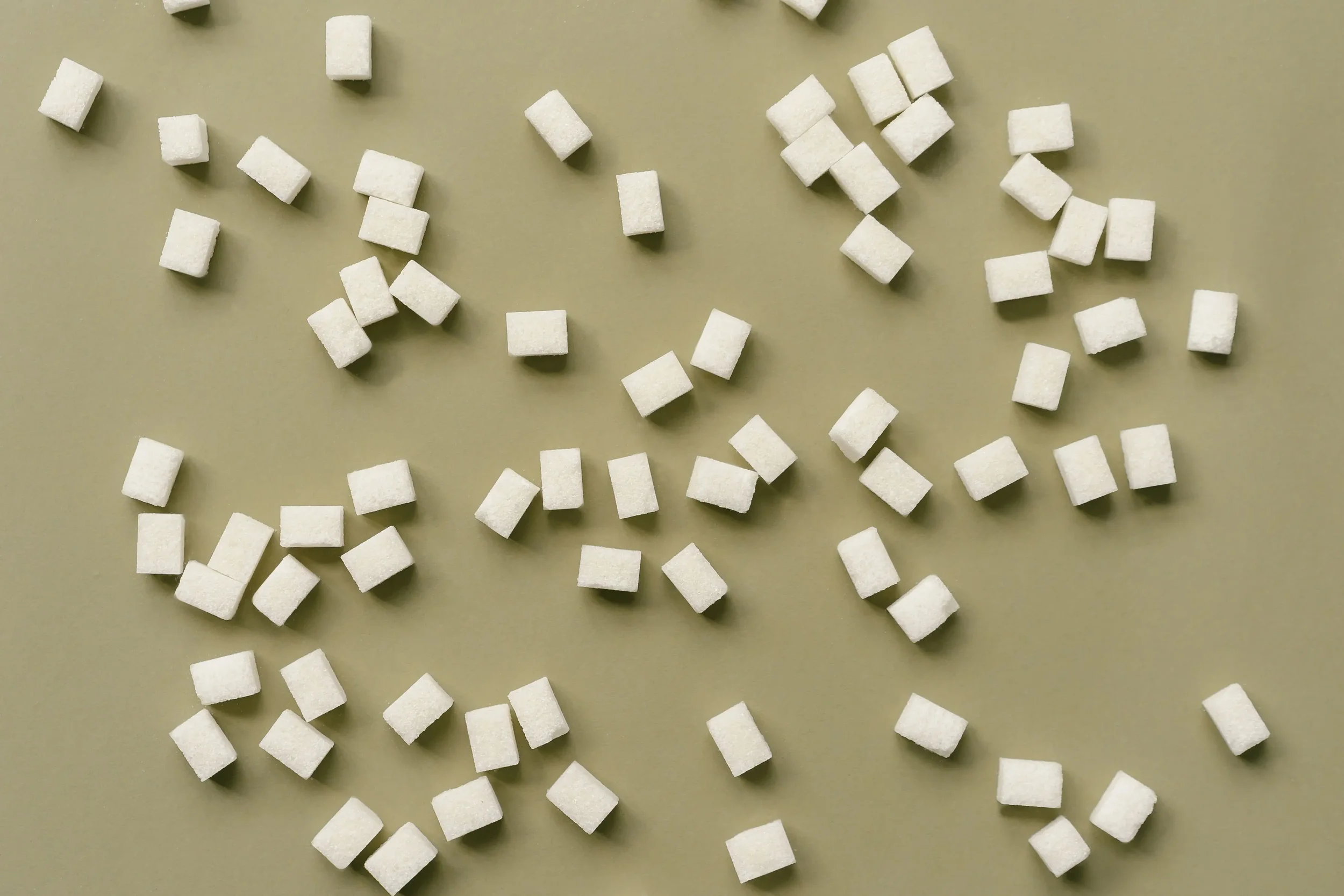 Photo of artificial sugar cubes on plain neutral background