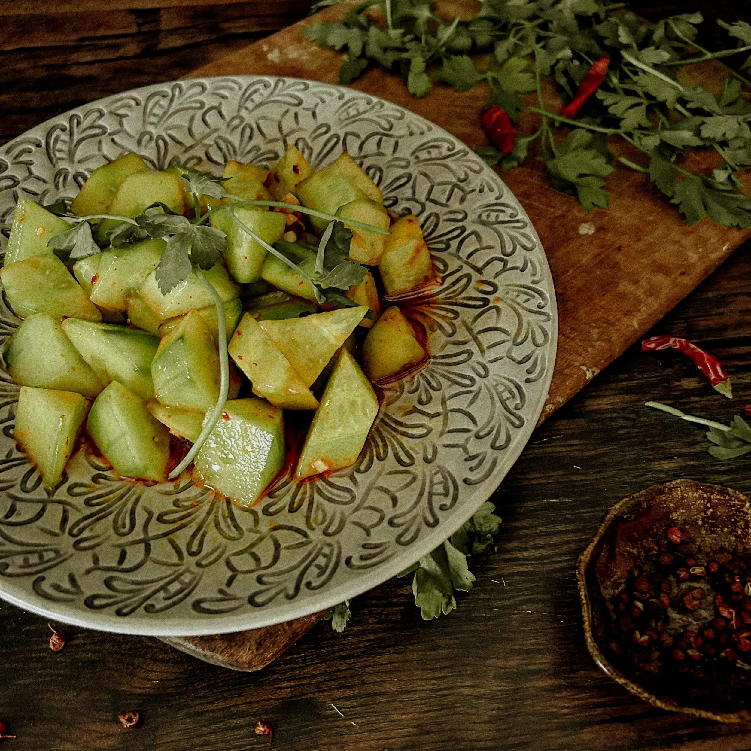 Refreshing and delicious Chinese cucumber and cilantro salad with chilli, sesame oil and sichuanese peppercorn created by London vegan meal prep service Sacred Nourish