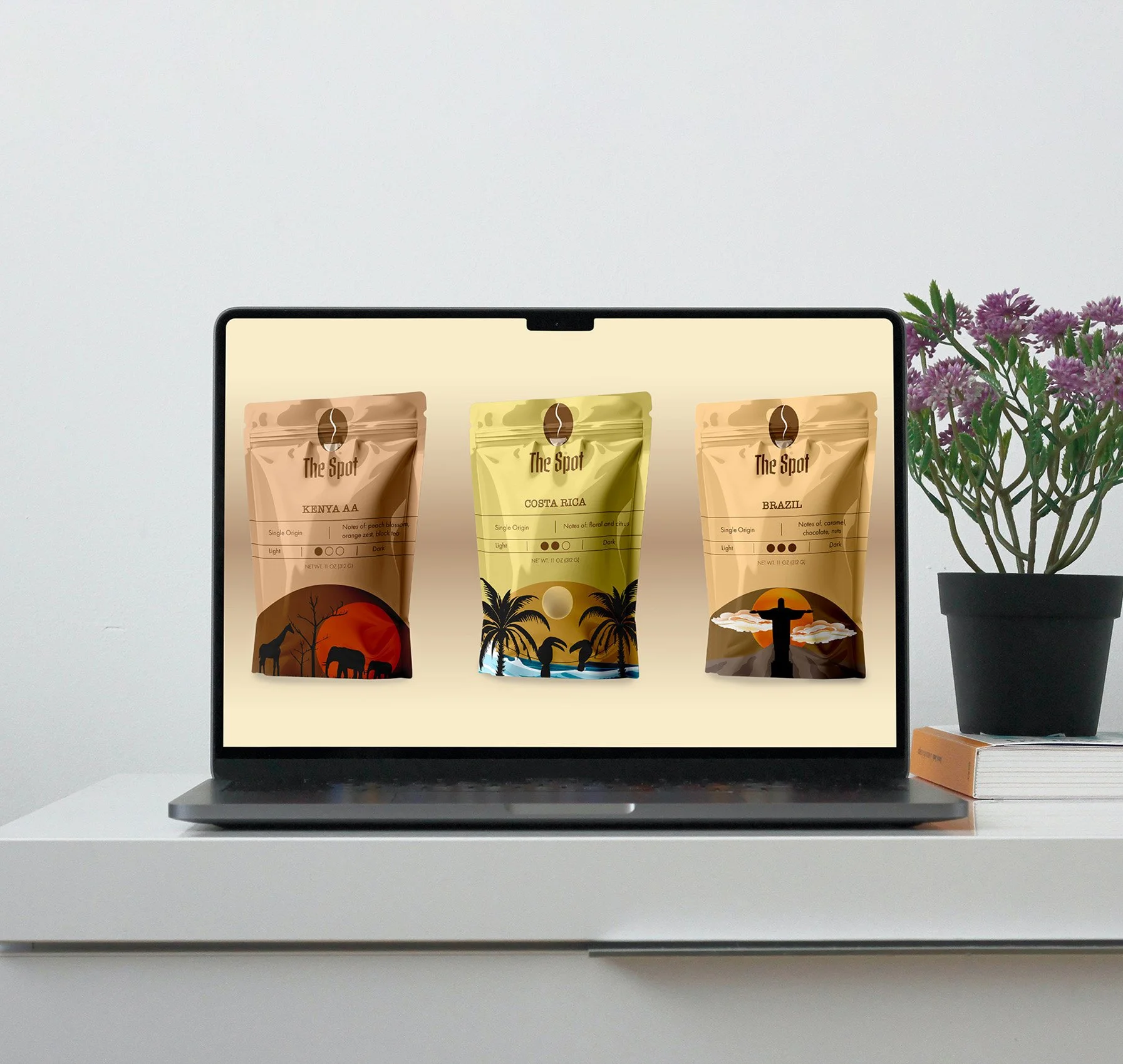 Laptop displaying three coffee bags labeled Kenya AA, Costa Rica, and Brazil, on a white surface with a potted plant and flowers beside it.