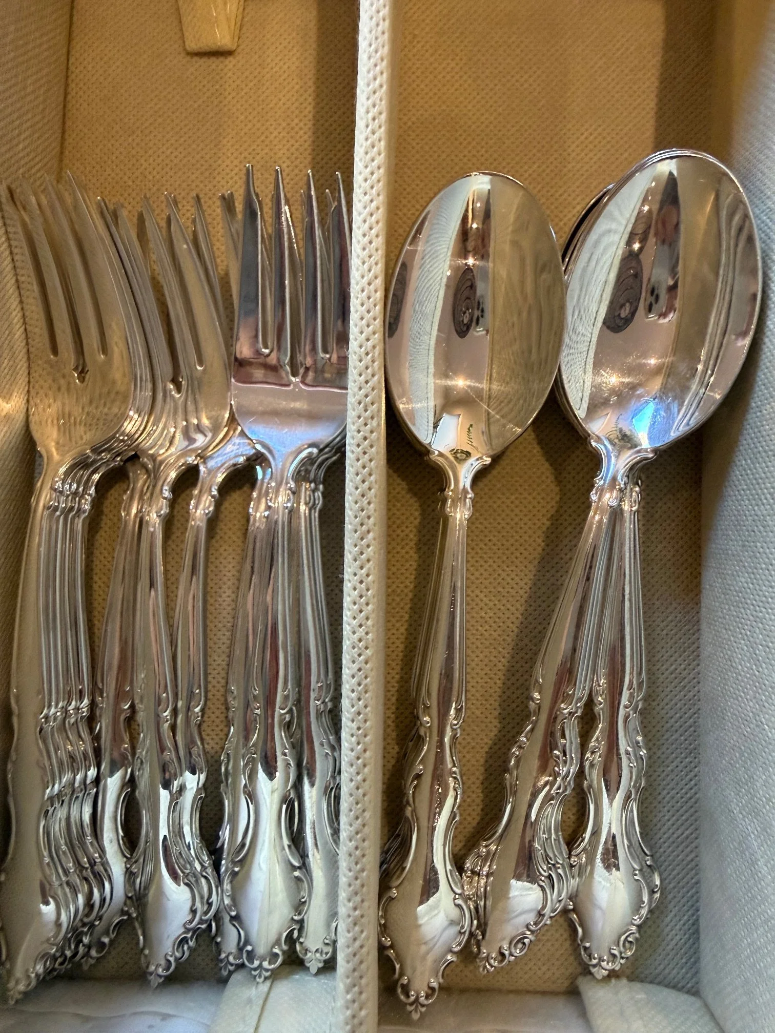 Colorful ceramic vases with traditional Asian designs on a wooden surface, with blurred background lights.
