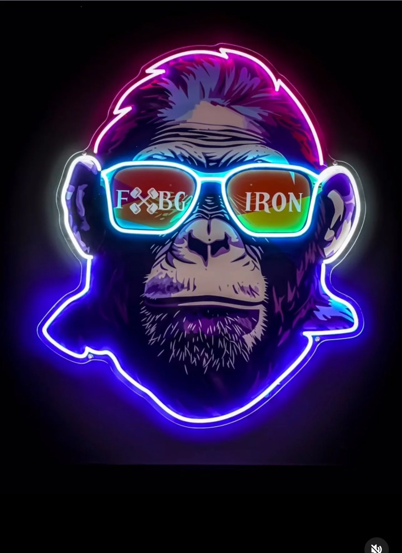 A neon sign of a chimpanzee wearing sunglasses with rainbow lenses, with text on the lenses reading 'F*CK IRON' and a neon outline of the chimp's face.