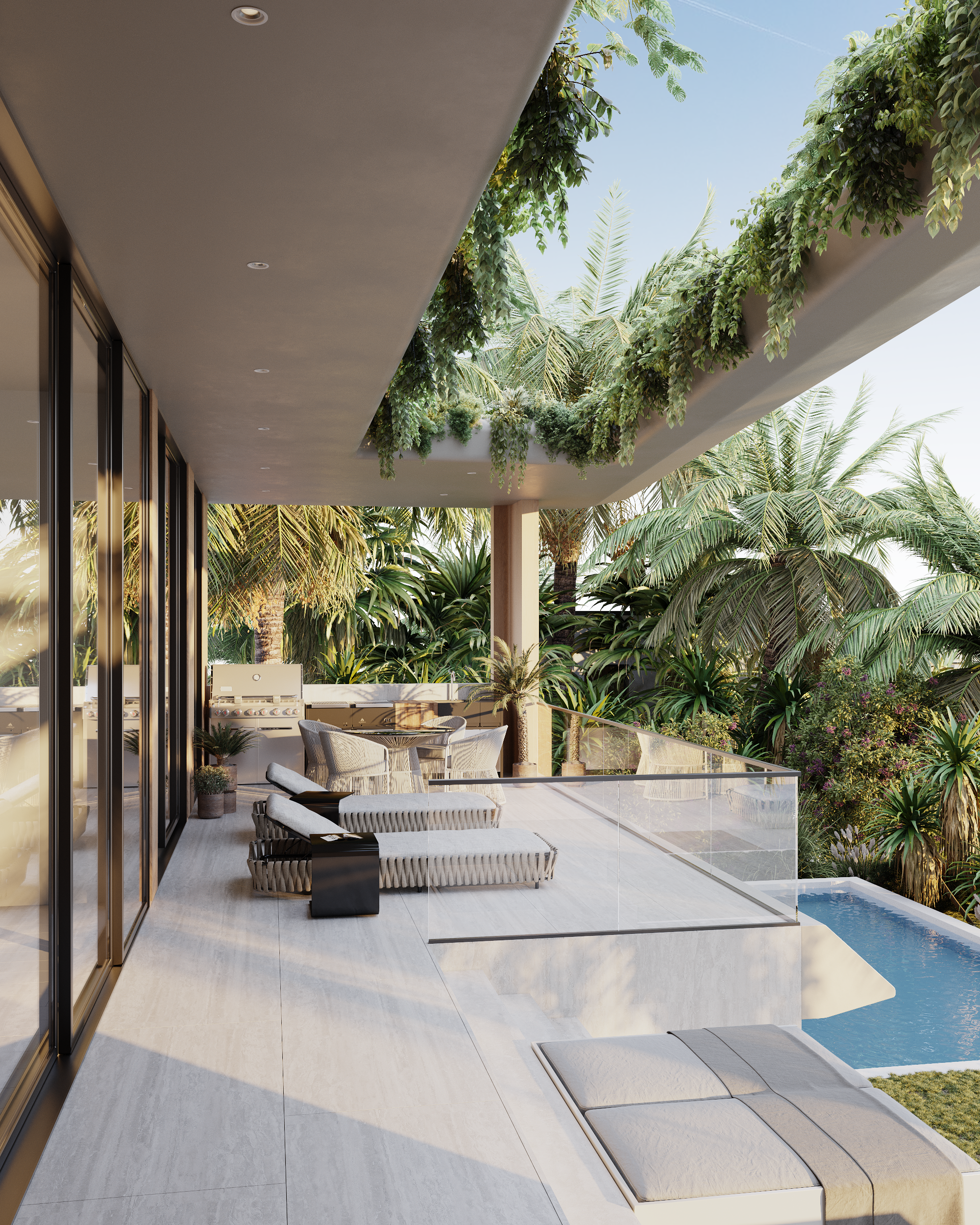 Modern outdoor balcony with lounge chairs, a dining table, and lush tropical greenery, including palm trees and flowering plants, with a swimming pool below.