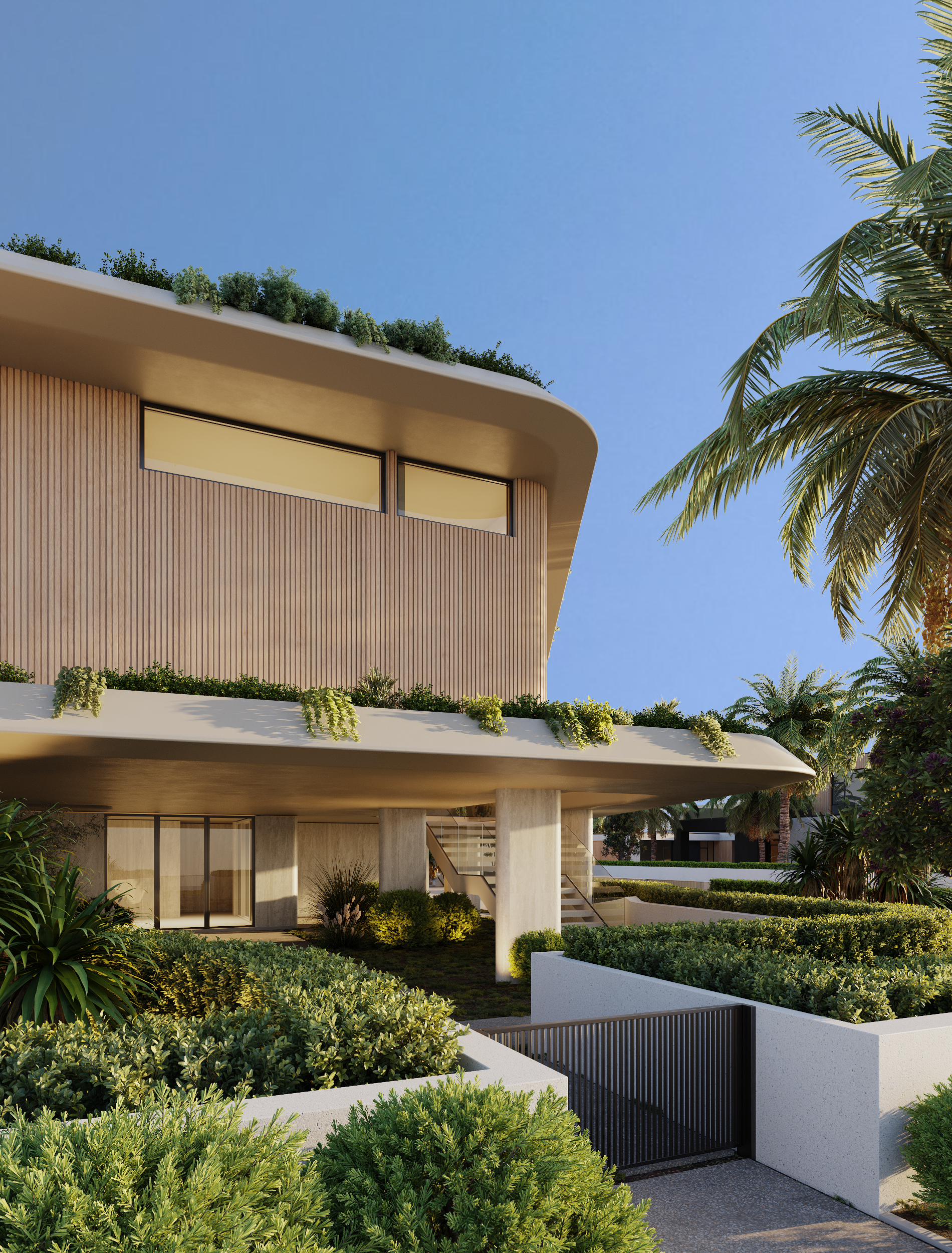 Modern house with curved roof, wooden siding, large windows, surrounded by lush greenery and palm trees, under a clear blue sky.
