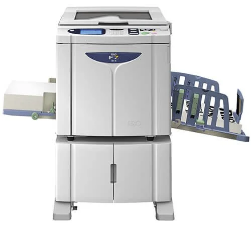 A dual tray paper printer with paper loaded in the tray and output tray.