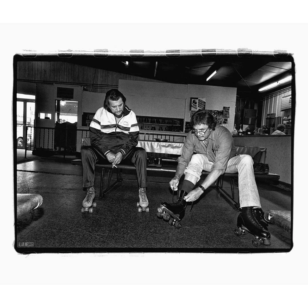 Waylon Jennings and Johnny Cash rollerskating by Alan Messer