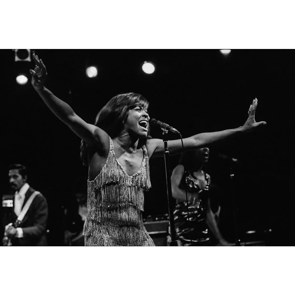 Tina_Turner_On_Stage+arms+out.webp