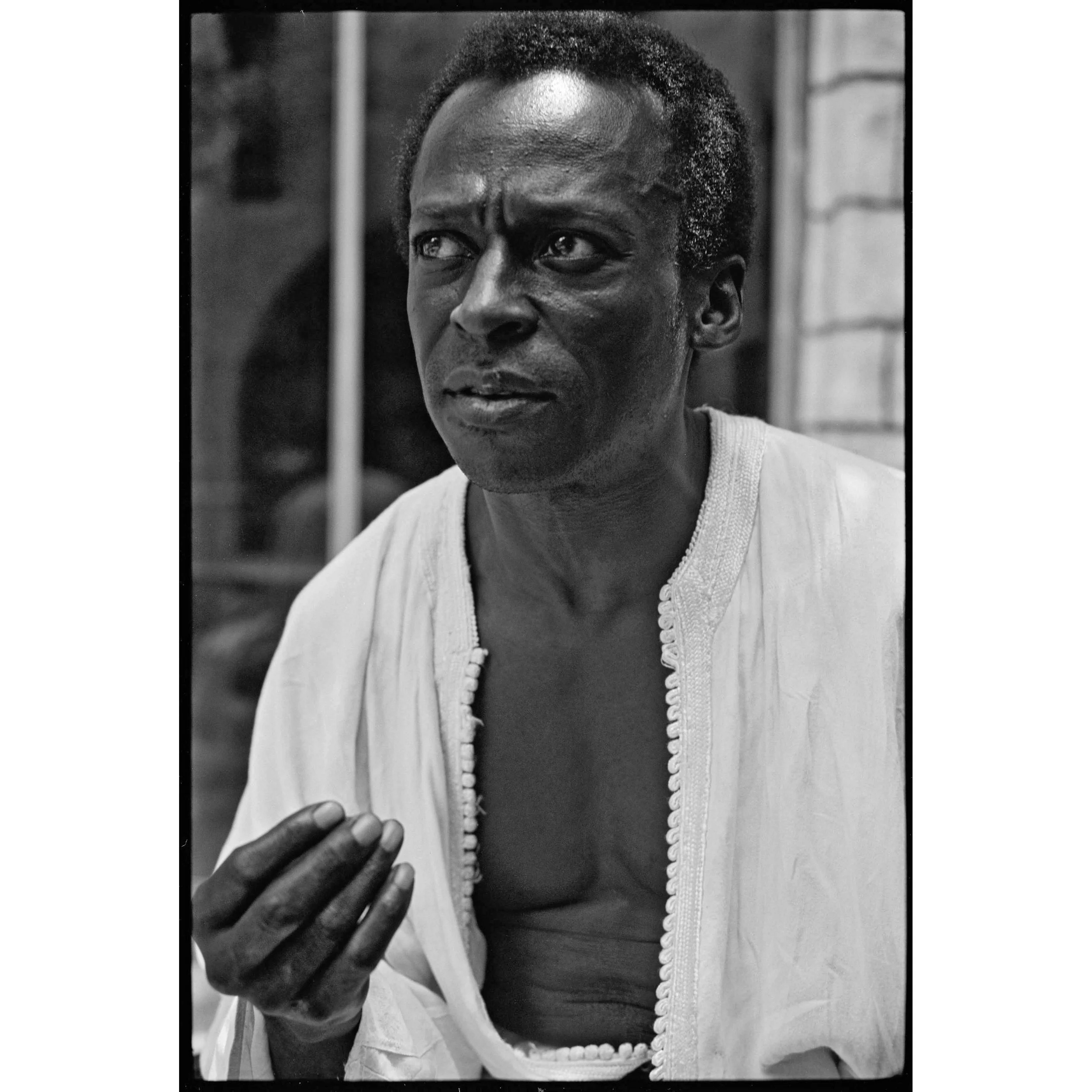 Miles Davis at home in white kaftan, Upper West Side, NYC, 1970 by Glen Craig