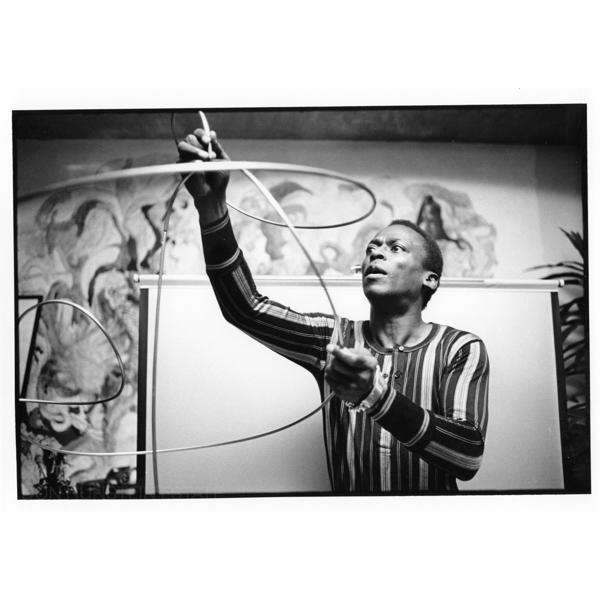 Miles Davis working on his art at home by Don Hunstein