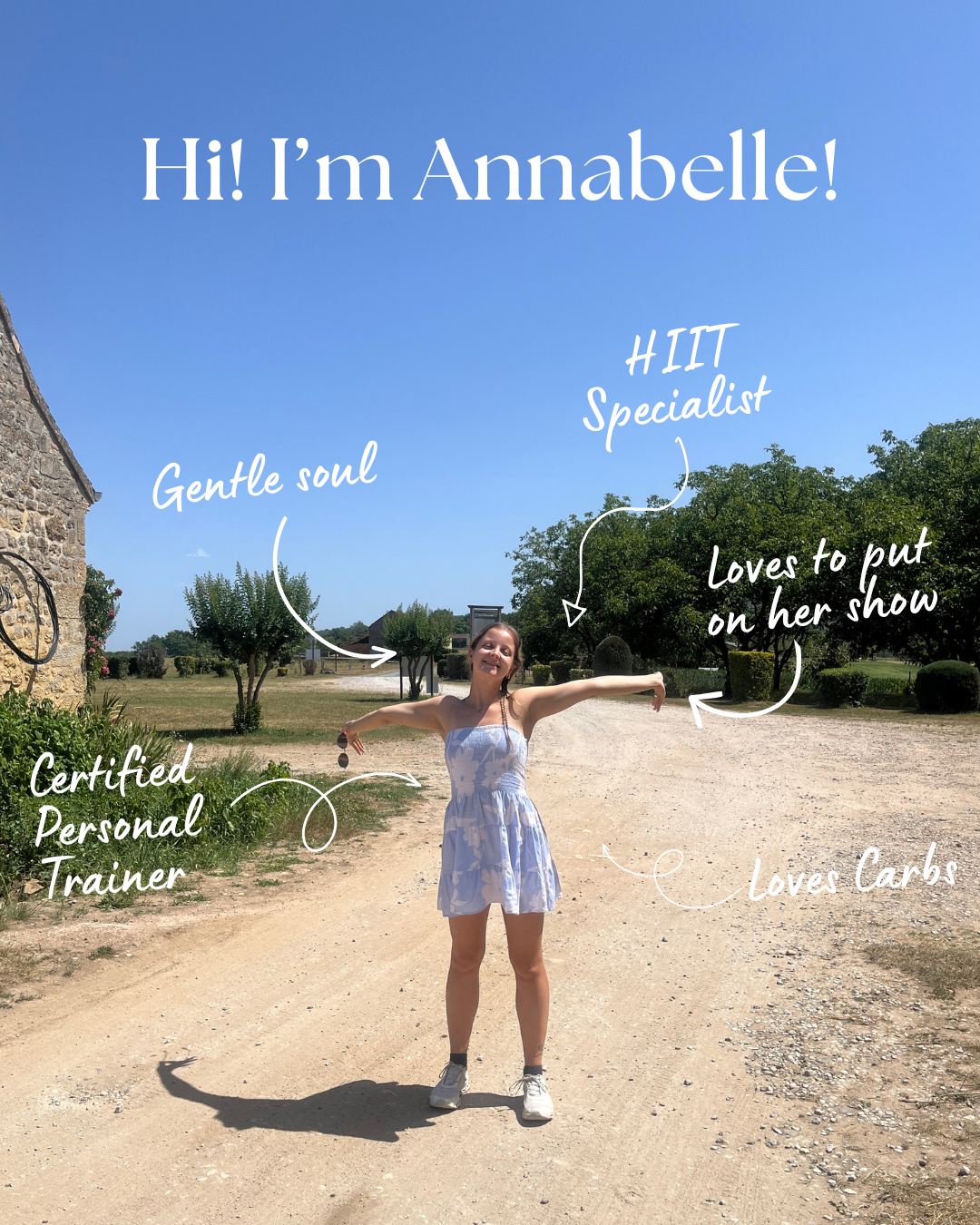 A woman standing outdoors on a sunny day in a light blue dress with white floral pattern, smiling and spreading her arms. The image has handwritten annotations introducing her as Annabelle, a certified personal trainer and HIIT specialist who loves to put on her show and loves carbs, and describing her as having a gentle soul.