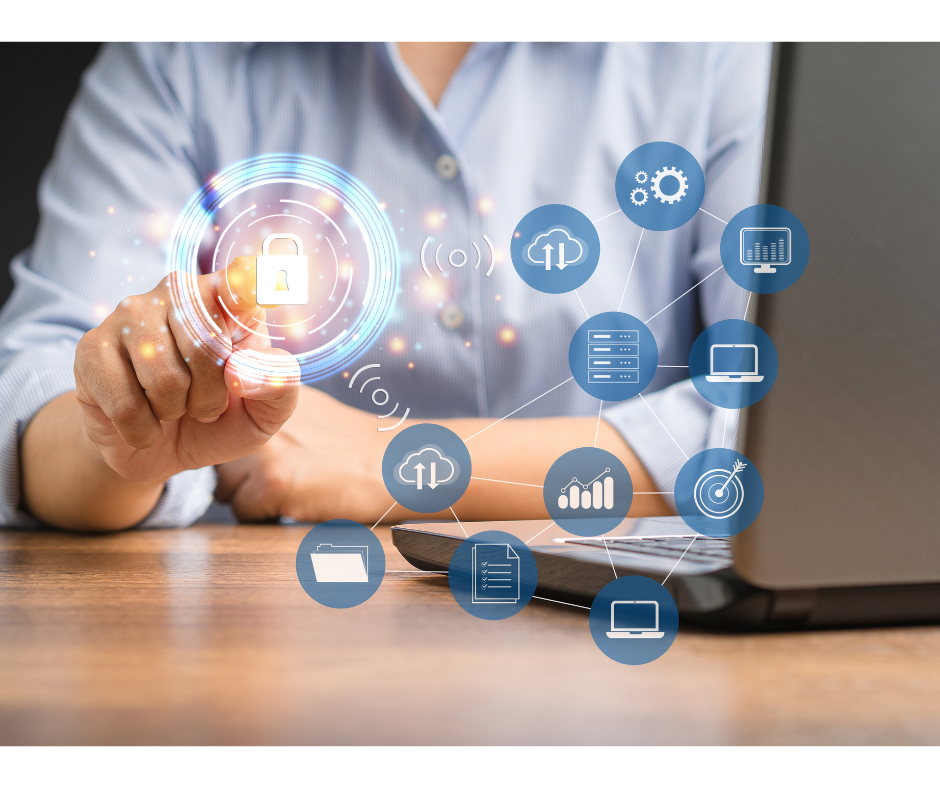 A person in a blue shirt interacts with a holographic digital interface featuring icons for security, cloud storage, data management, analytics, and devices, with a laptop on a wooden desk.
