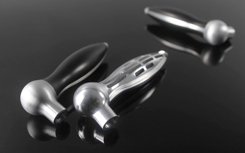 CNC machined parts with over-molded urethane grips.