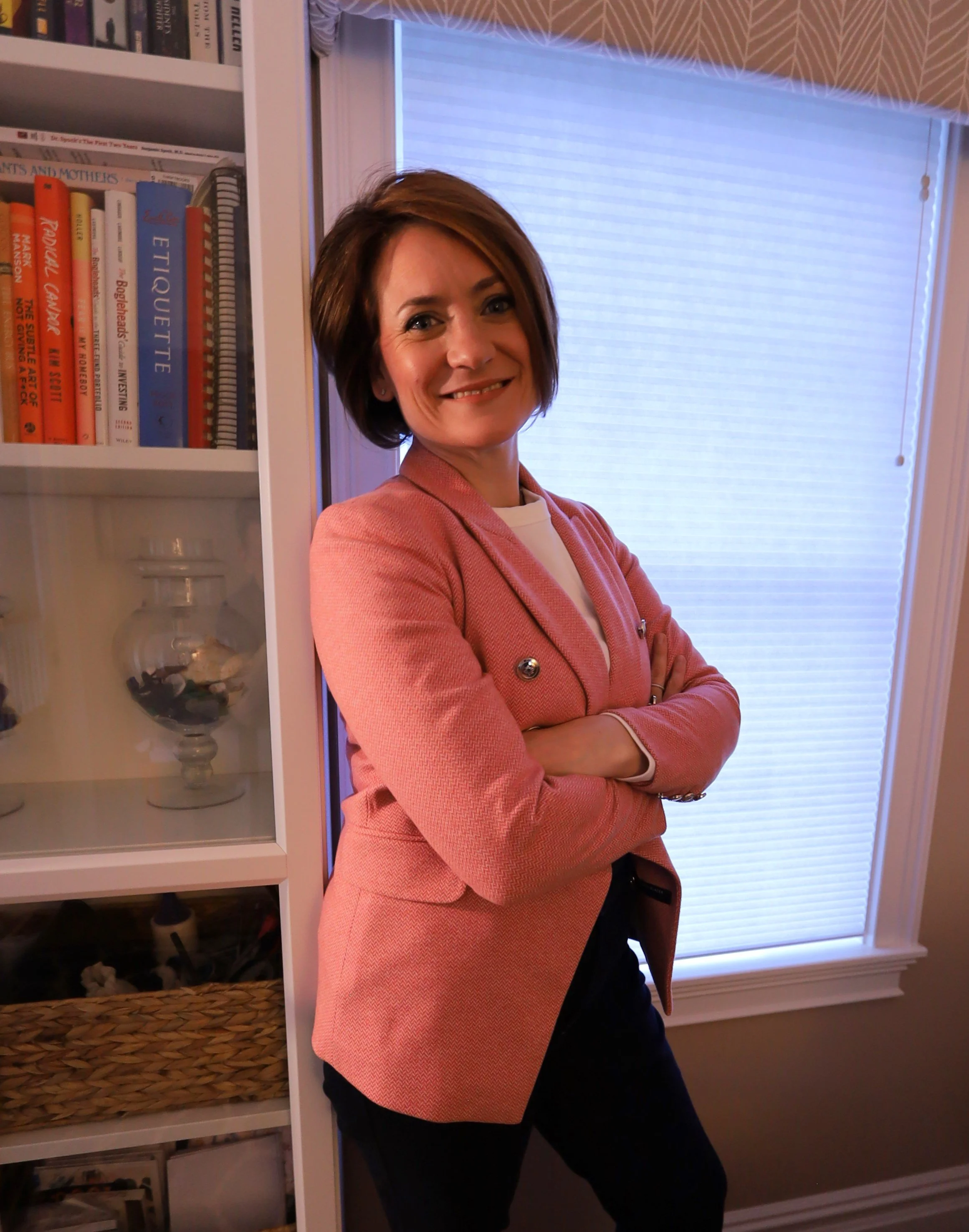 Professional home organizer and founder of Arranged by Abigail in her thoughtfully arranged home office, showcasing a calm, modern approach to home organization and styling.