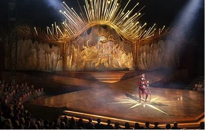 Cirque du Soleil performers onstage beneath the illuminated golden set of Alegría.