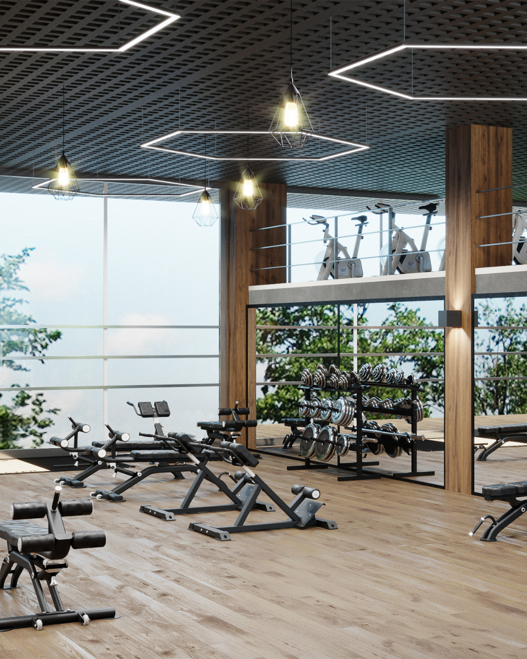 Modern gym with weightlifting equipment, cardio bikes on a mezzanine, and large windows with greenery outside.