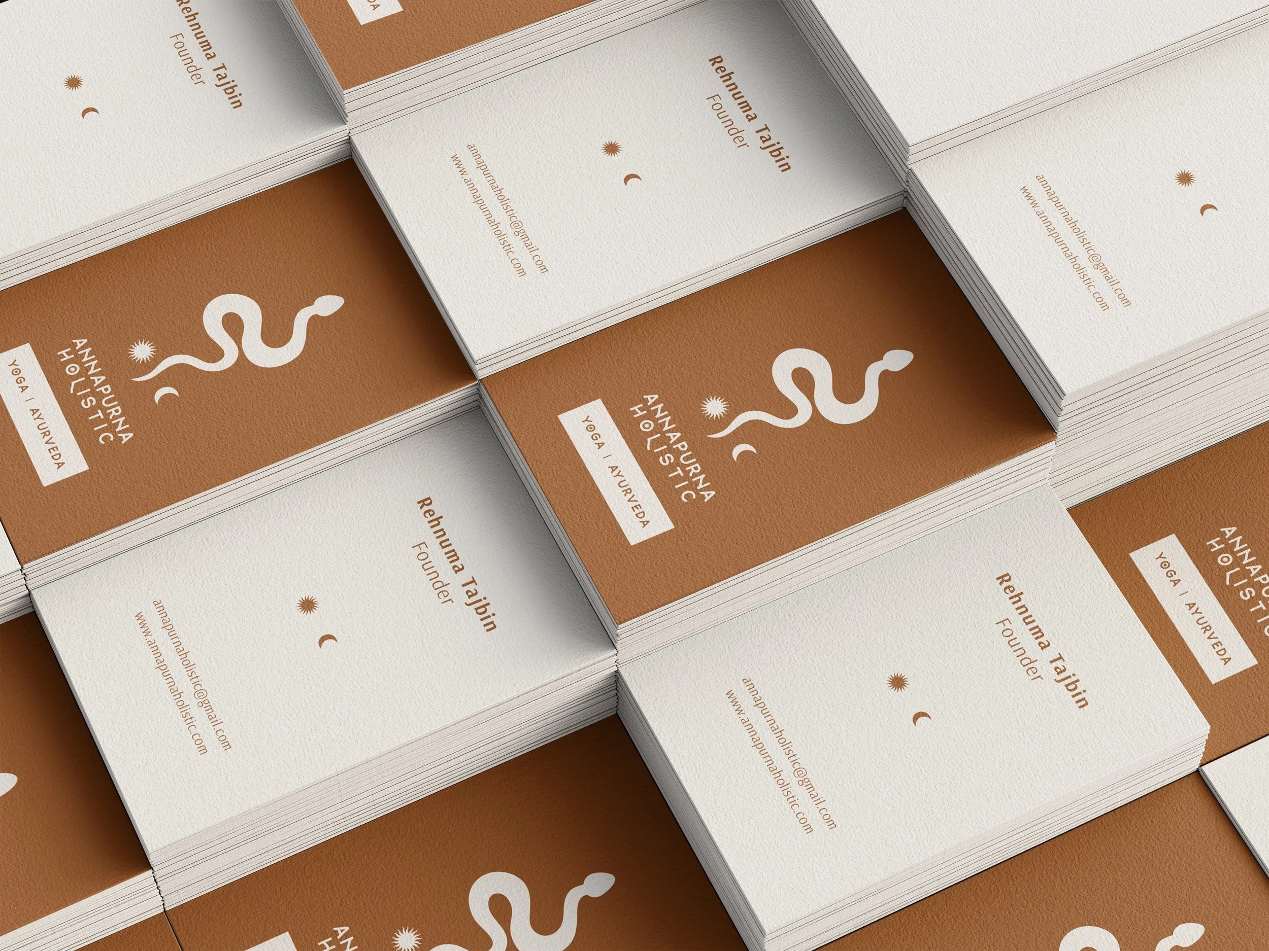 Stacked business cards for Rehnuma Tajbin, a yoga and Ayurveda founder, featuring a minimalist design with a white snake logo on a brown background and contact information on a white background.