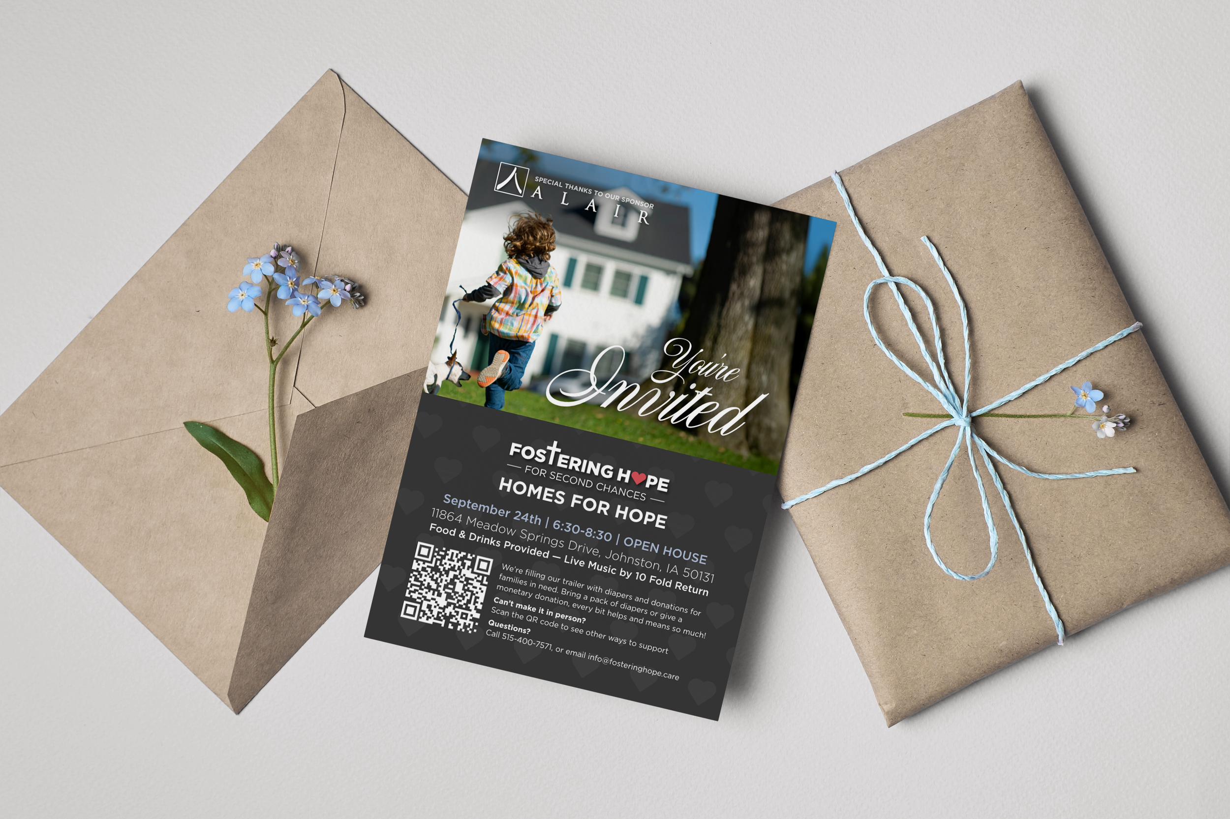 A flyer for a homes for hope event featuring a child riding a scooter in front of a house, placed between two wrapped brown paper gift envelopes decorated with blue flowers and tied with light blue string.