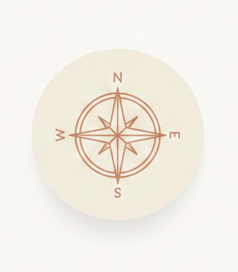 A coin featuring a compass rose design with North, South, East, and West directions marked.