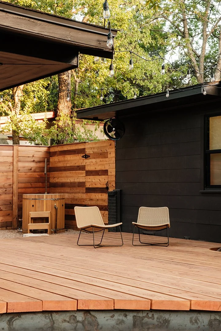 A real wood deck built by BigDecks with seating, privacy fencing, and outdoor lighting.