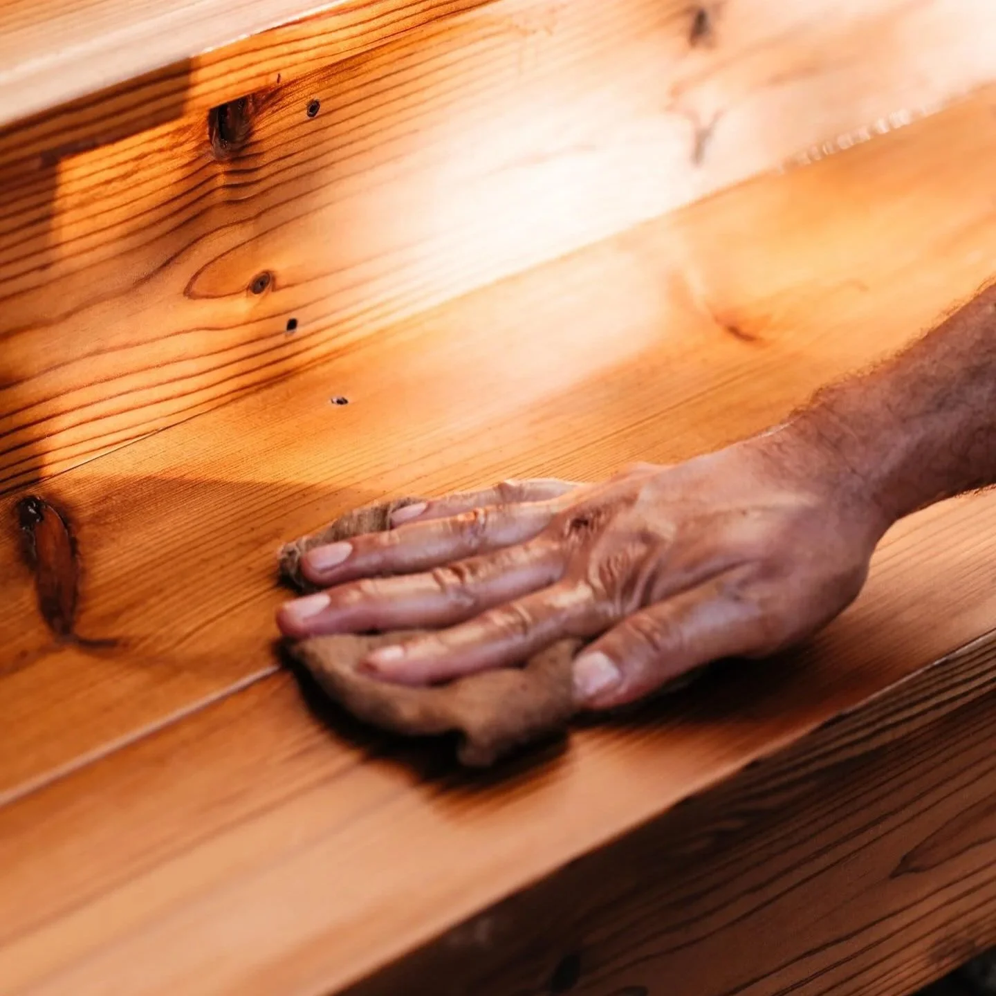 Detail of hand-applied oil finish on a real wood deck.