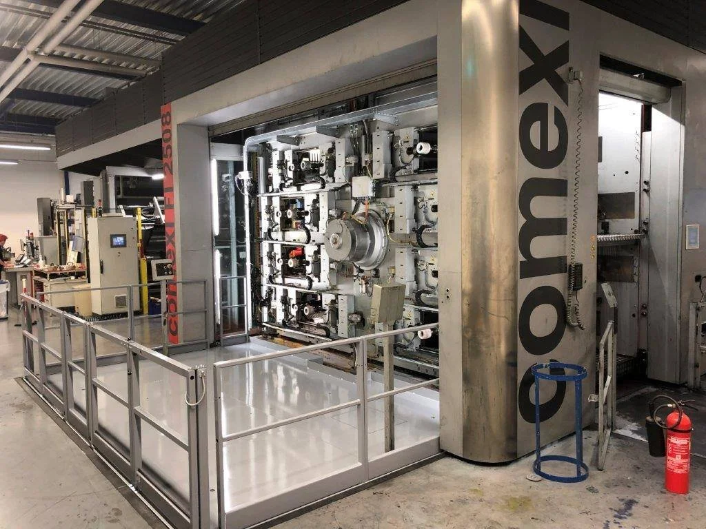 Large industrial 3D printer with the brand name 'Corem' on it, set in a factory or workshop.