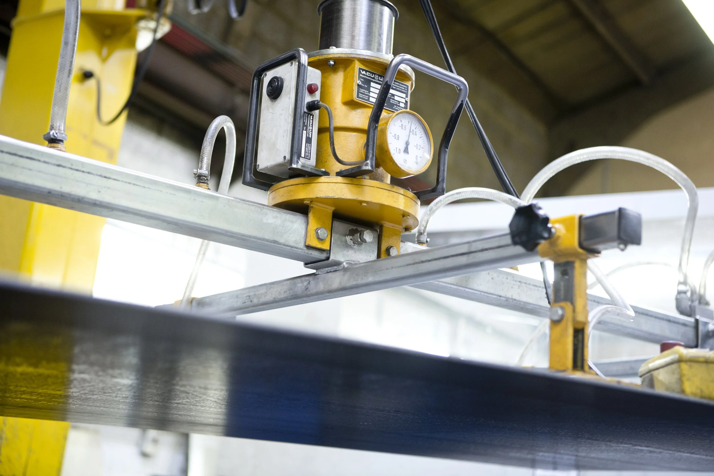 Industrial machine with gauges and metal framework in a manufacturing or workshop setting