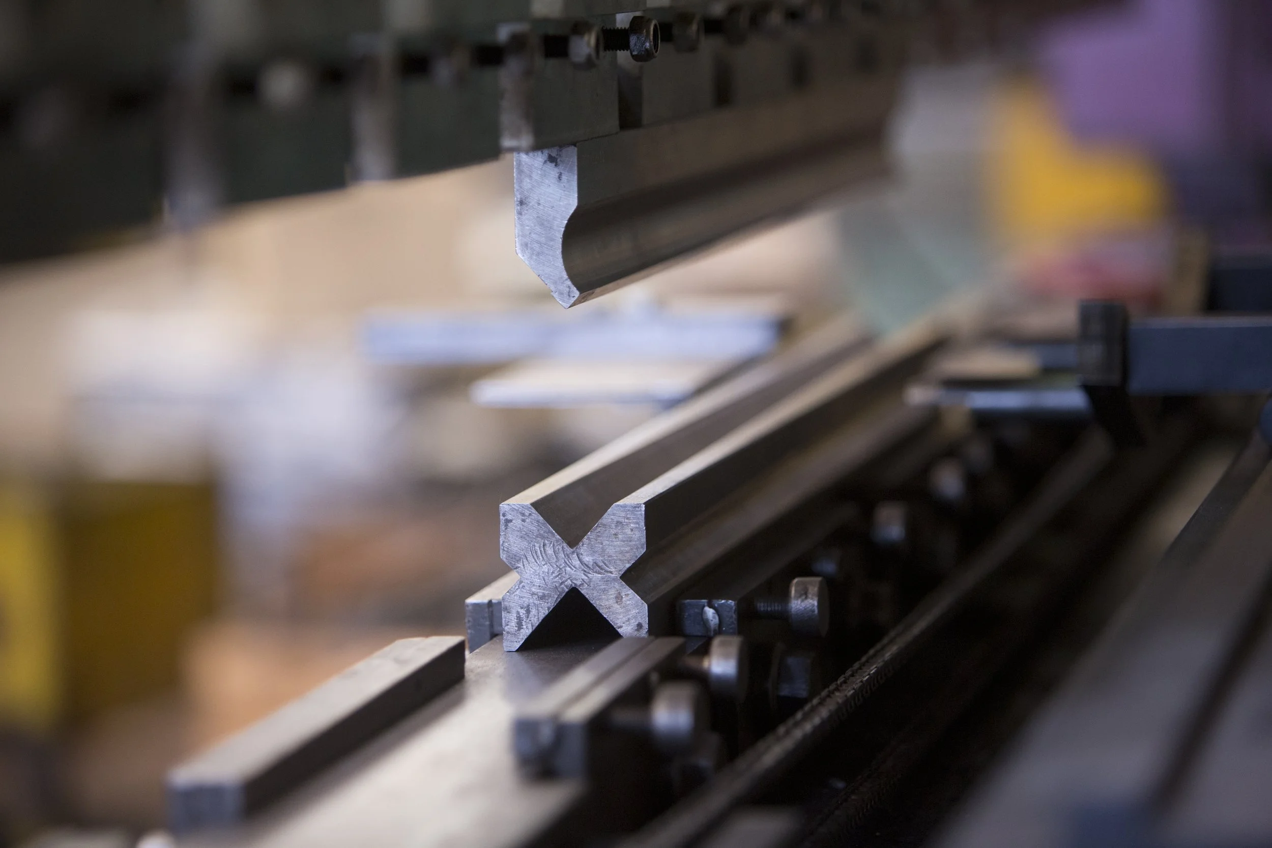 Metal L-shaped beams on a worktable in a workshop or manufacturing setting.