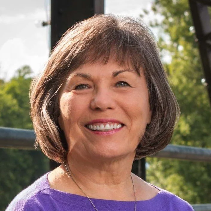 Smiling middle-aged woman with short brown hair who is happy because she hired a professional organizer and decluttering specialist for her garage in Rome, Georgia. 