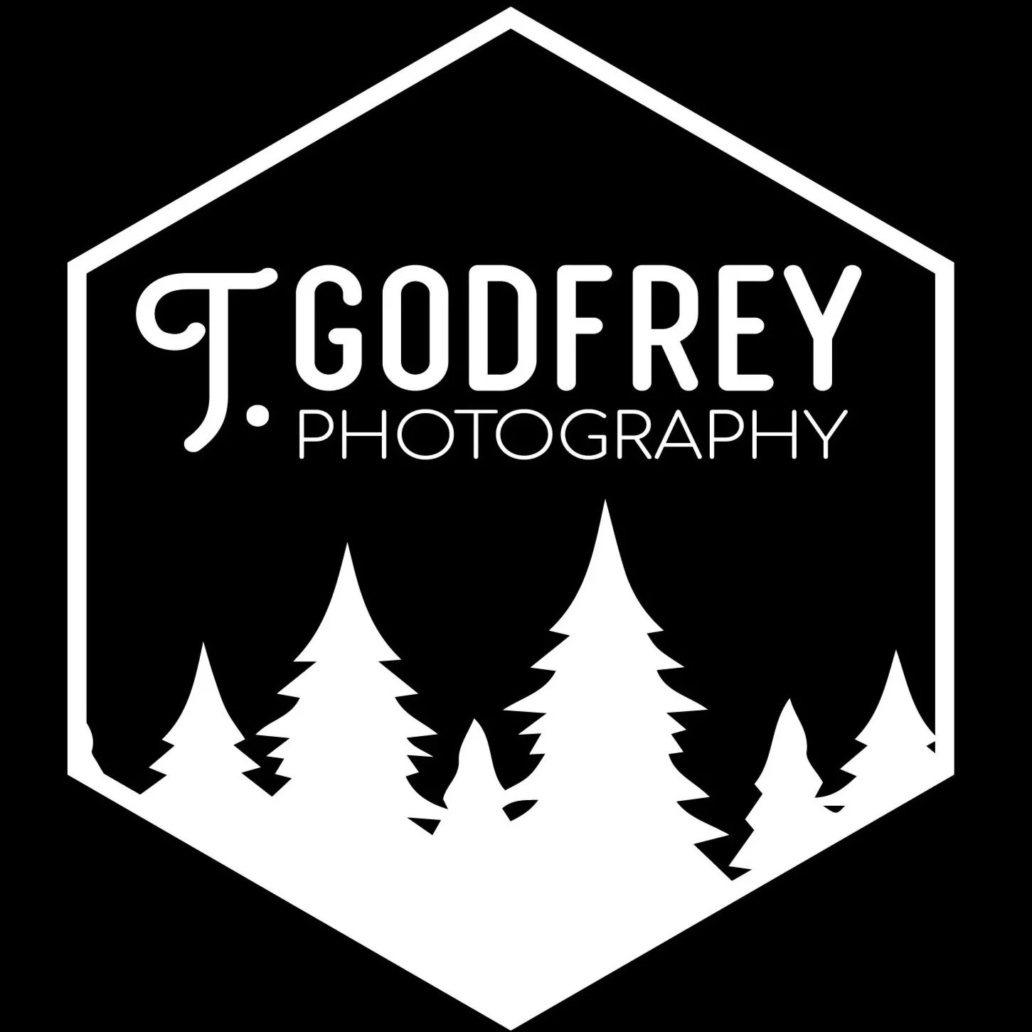 Black and white logo with the text 'J. Godfrey Photography' and a stylized house outline containing pine trees.