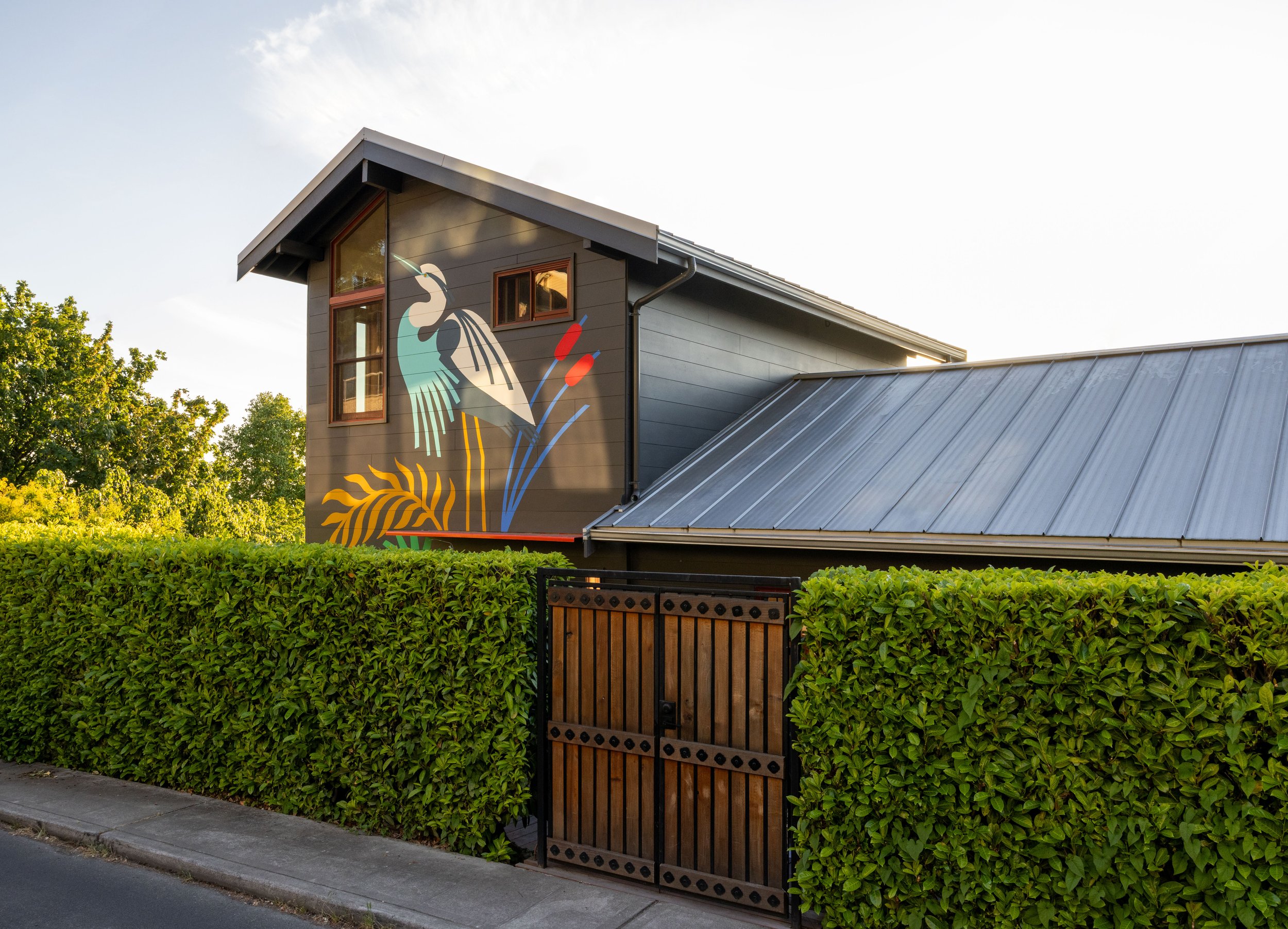 New exterior envelope, including foundation repair, waterproofing, and siding, with mural by Stevie Shao.