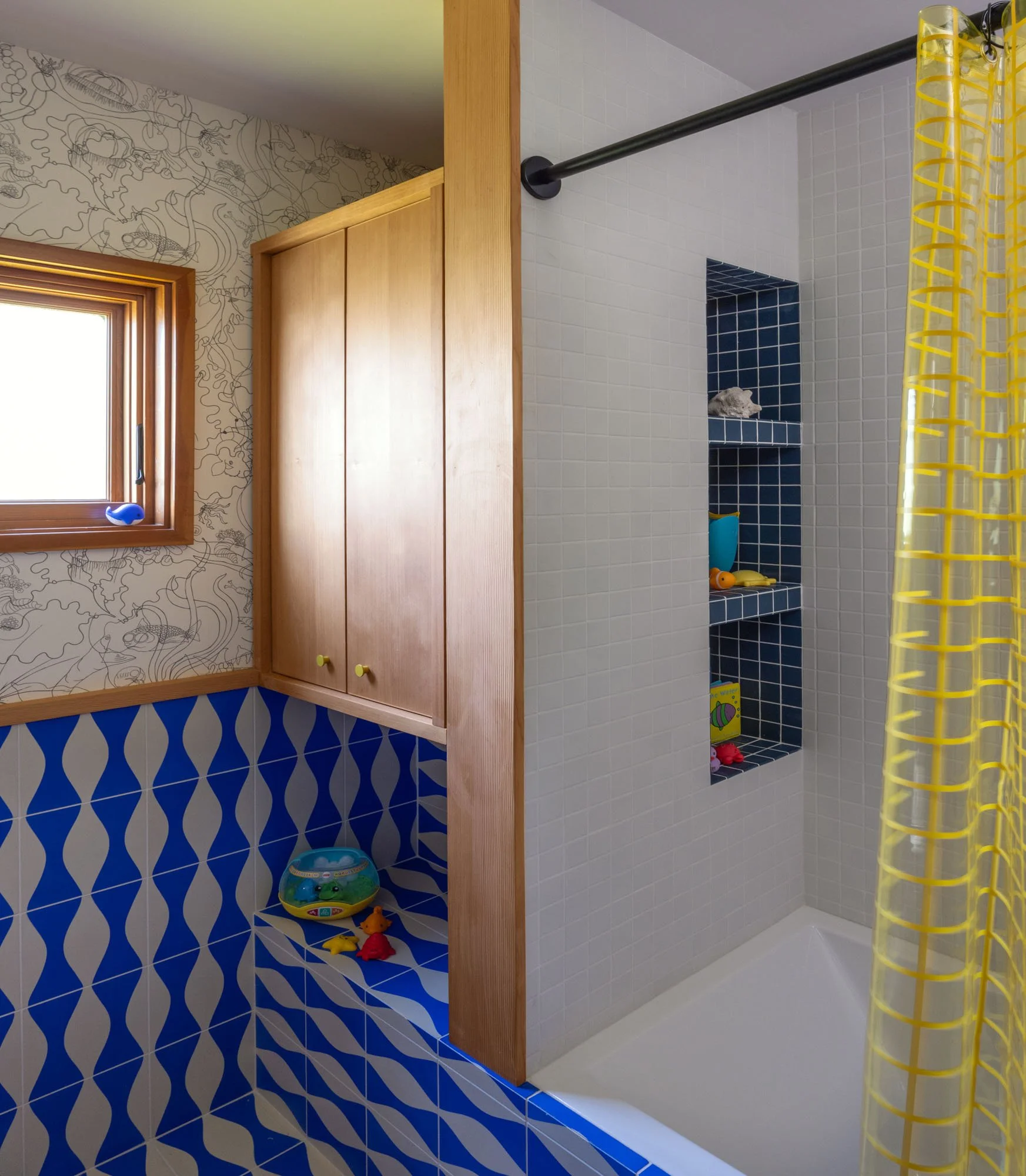 Remodeled bathroom with custom cabinetry and tile.