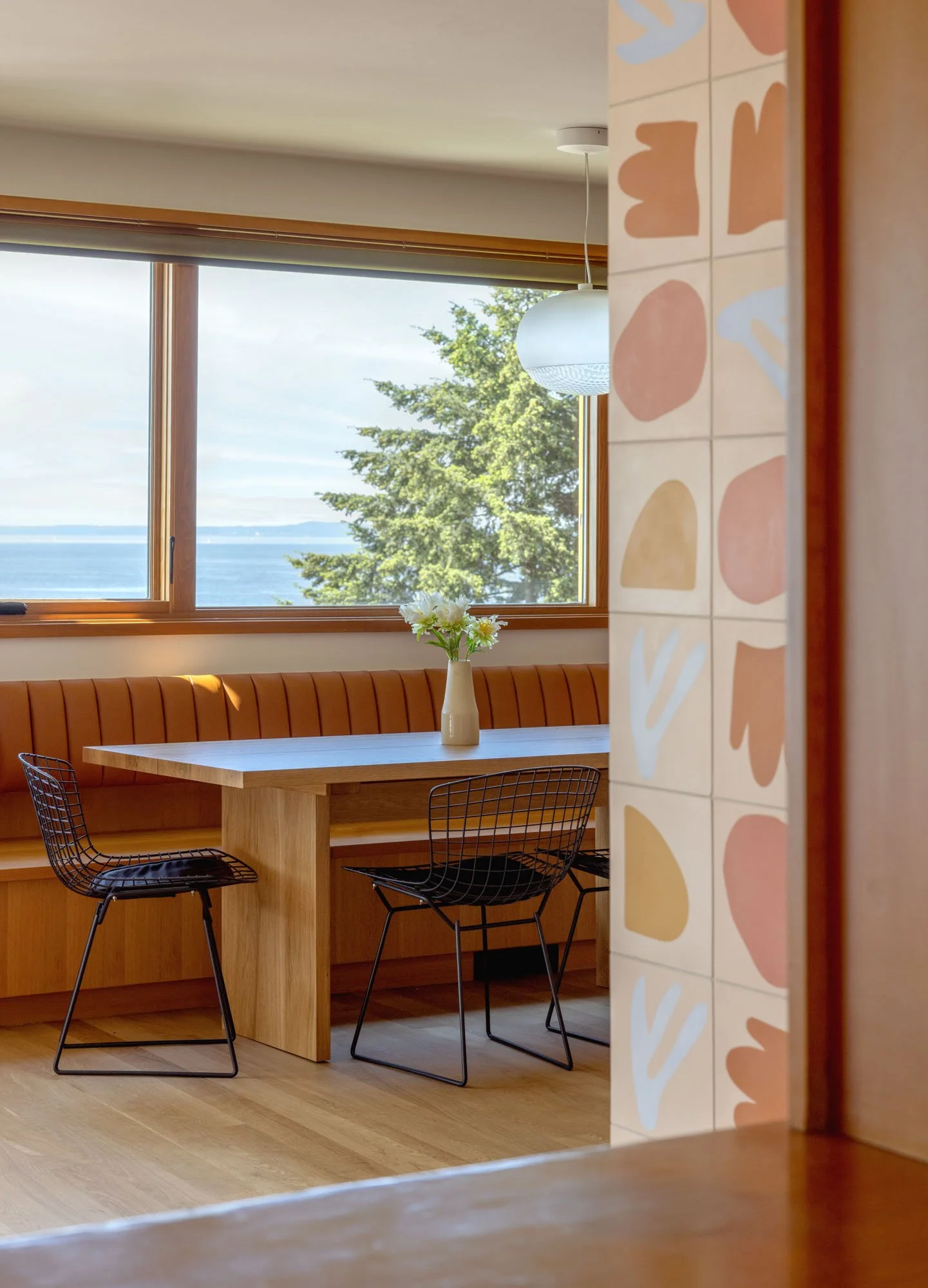 New, remodeled kitchen with custom fir cabinetry and banquette, Concrete Collaborative countertops, and Zia Tile backsplash.