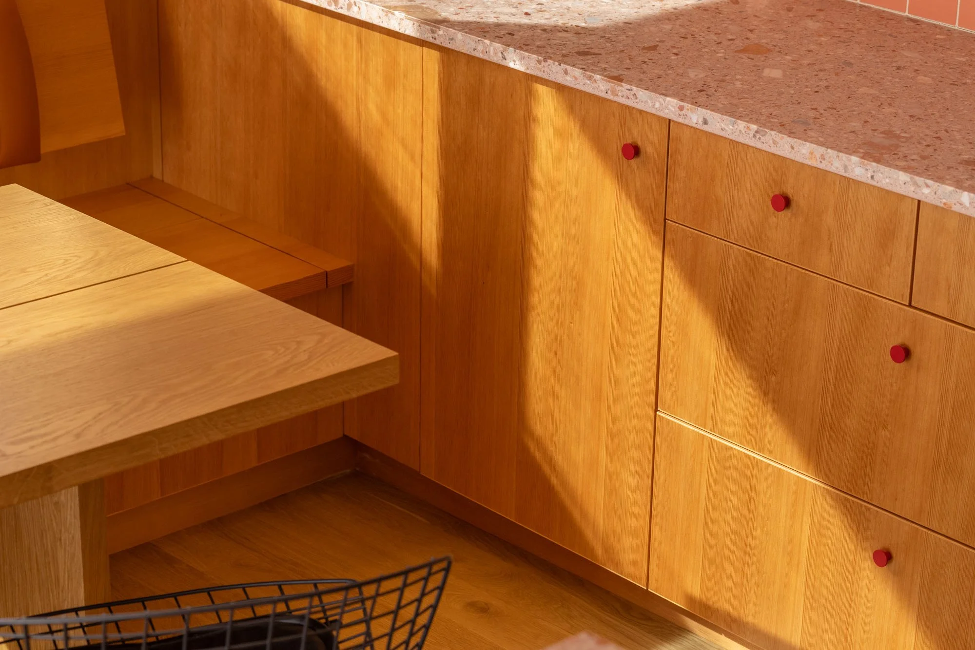 Remodeled kitchen with custom fir cabinetry and banquette made in the Bucktide woodshop and Concrete Collaborative countertops.