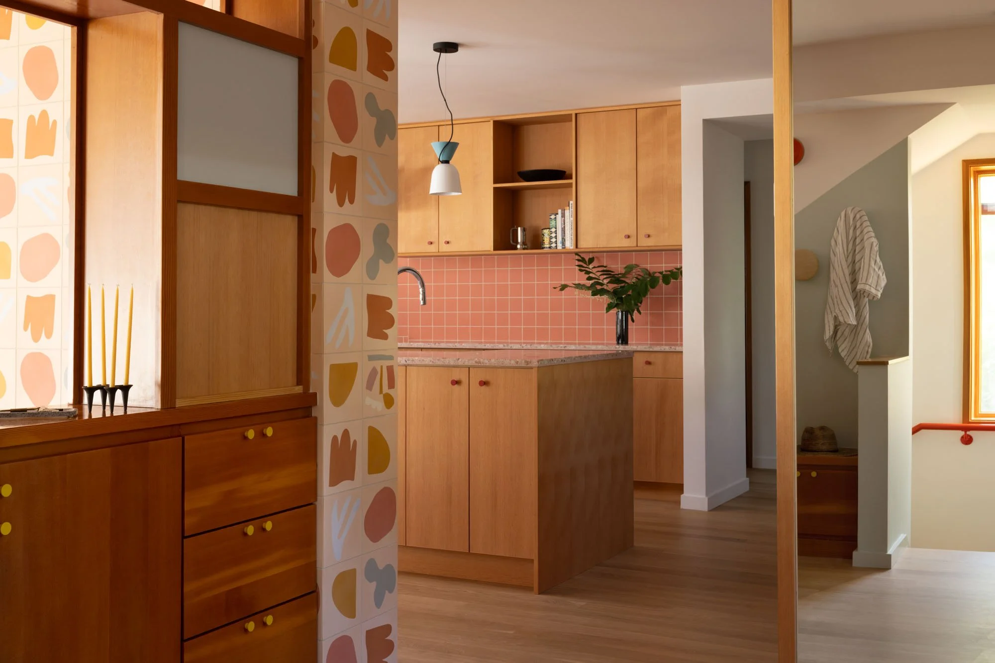 Remodeled kitchen with custom cabinetry and refurbished entry cabinet.