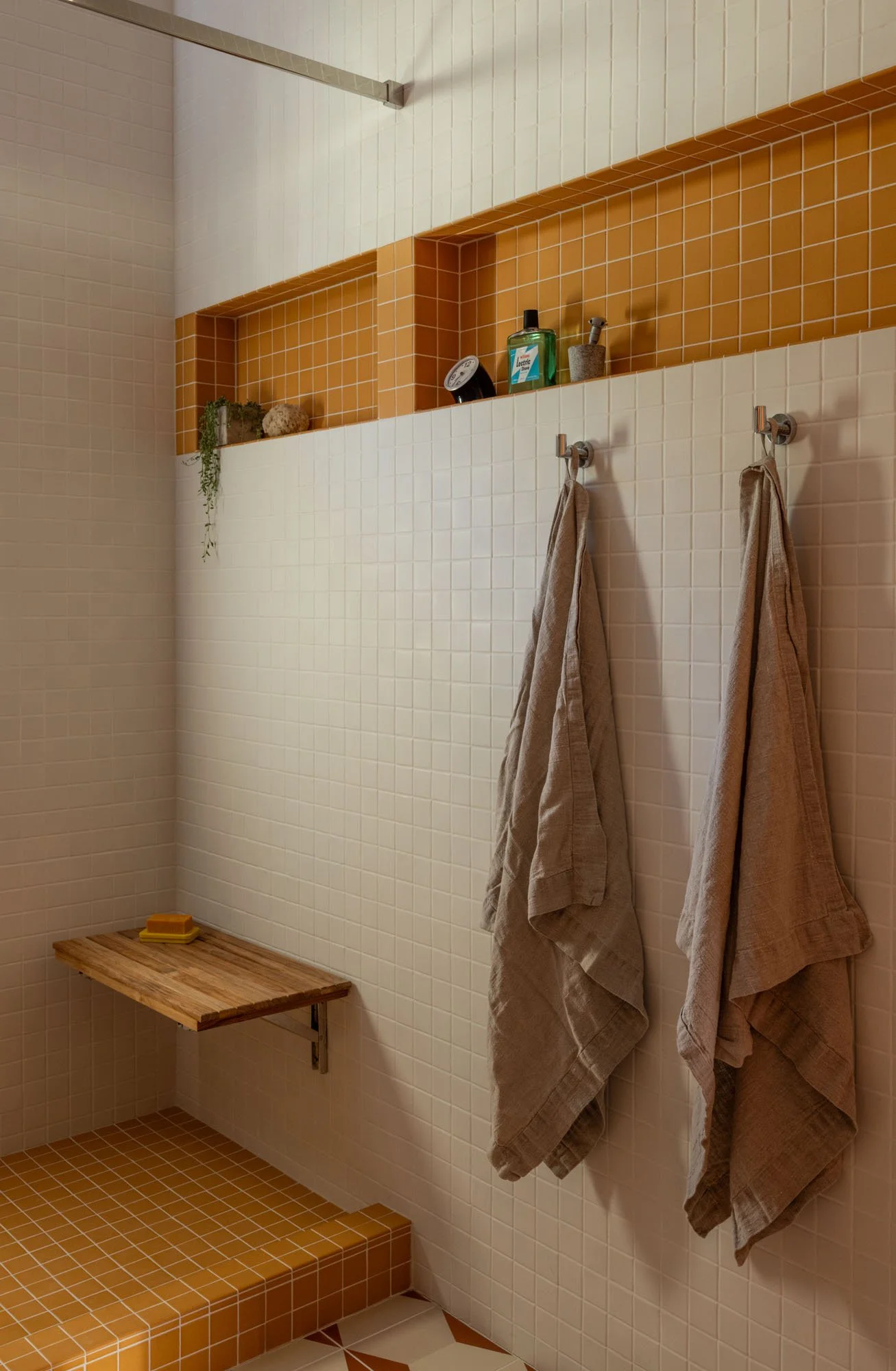 Remodeled bathroom with custom cabinetry and tile.