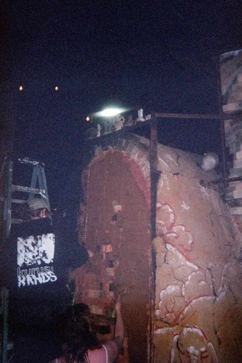 Meg and Azelia sealing the door with clay.