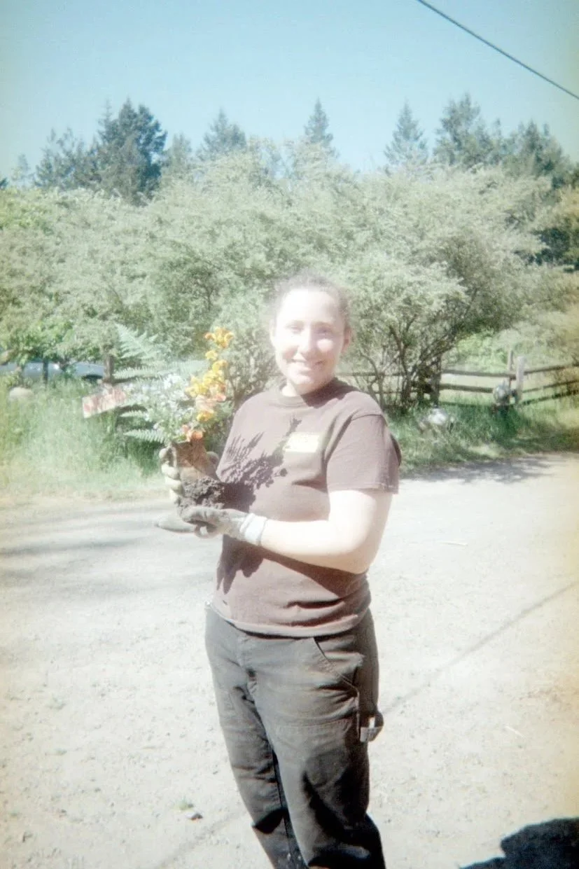 Charley and her flower offerings for the kiln. Disposable camera photo by Jules.