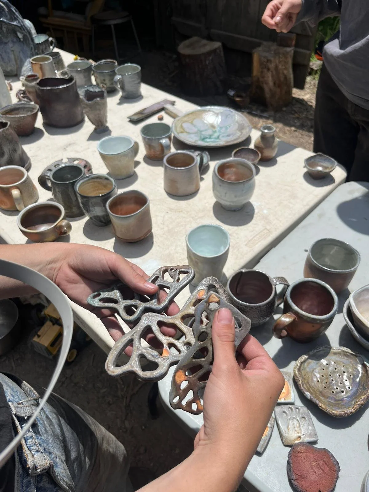 Jules holding butterfly wings they fired in the kiln